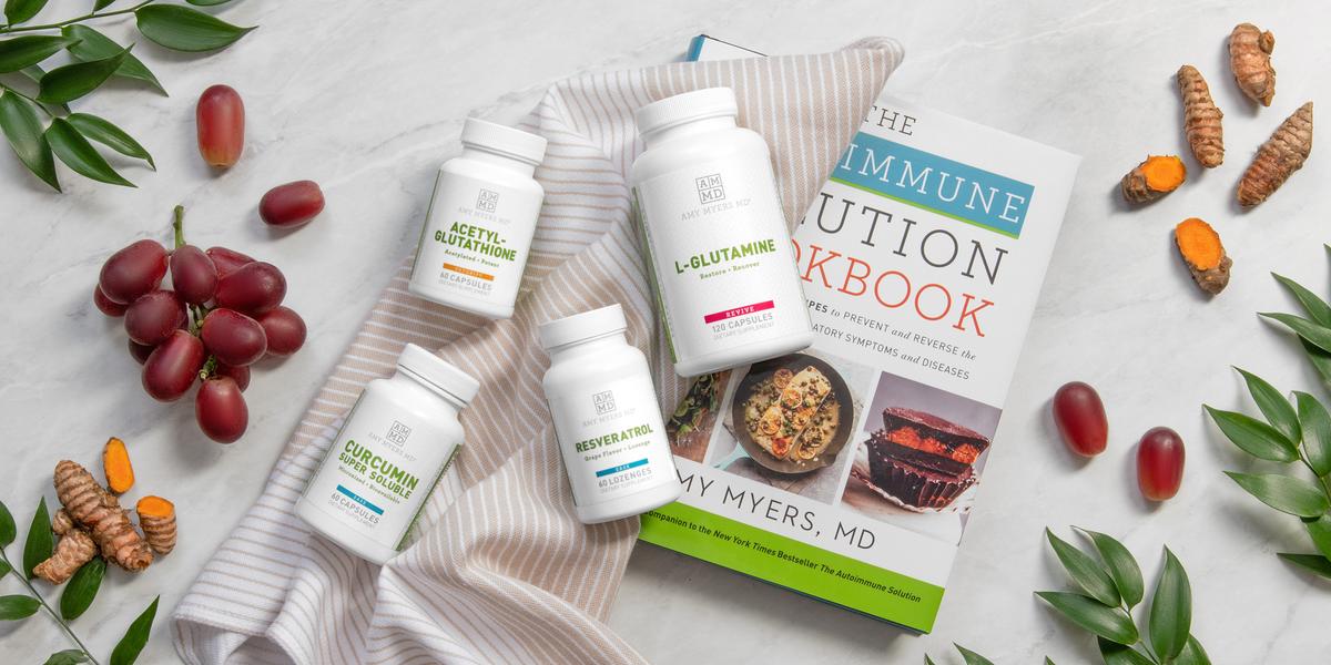 Autoimmune Kit products, L-Glutamine, Acetylglutathione, Curcumin Super-Soluable, Resveratrol, and the Autoimmune Solution Cookbook laid out on a table.