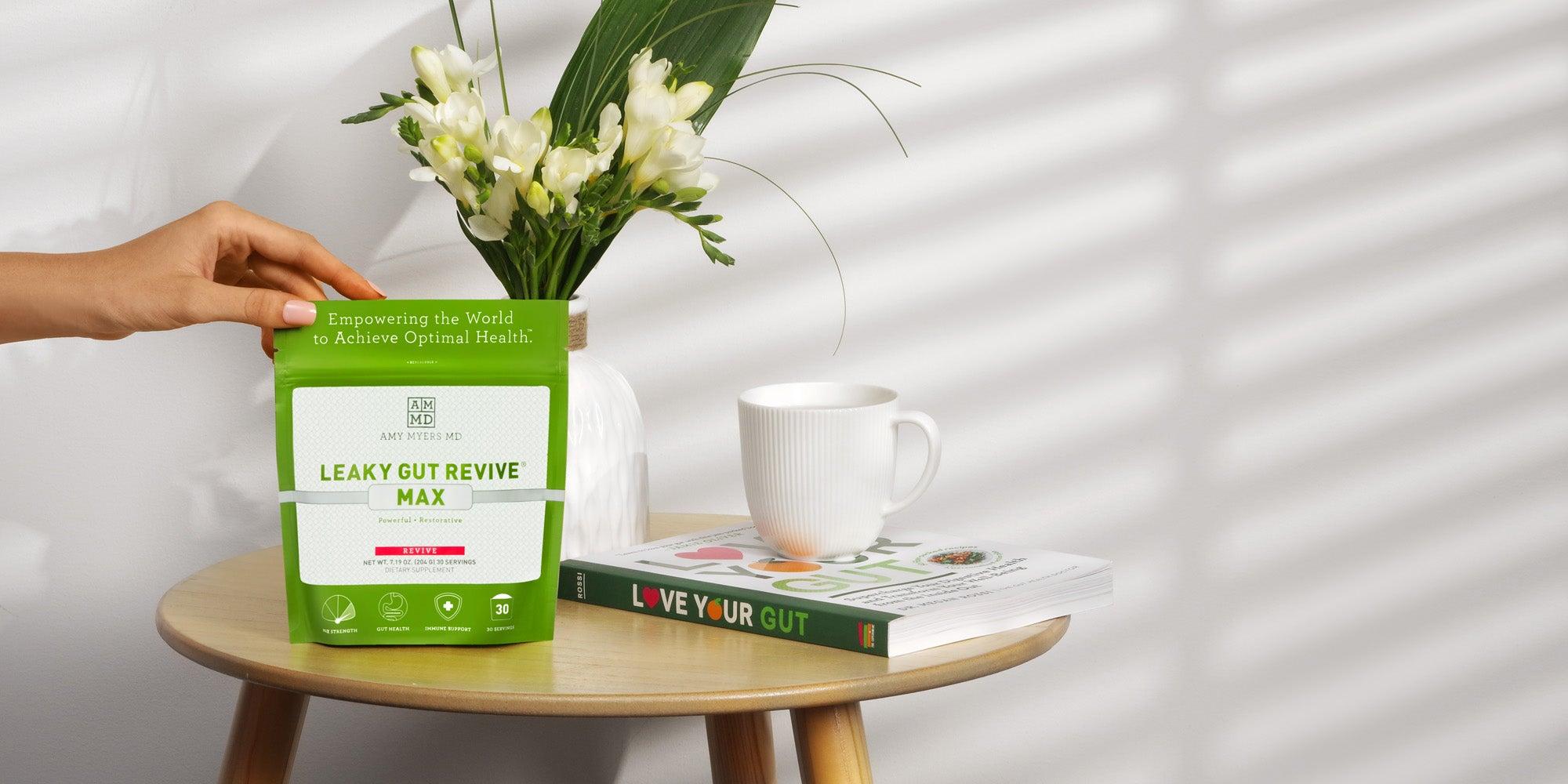 Leaky gut revive max product with a flower vase and mug.