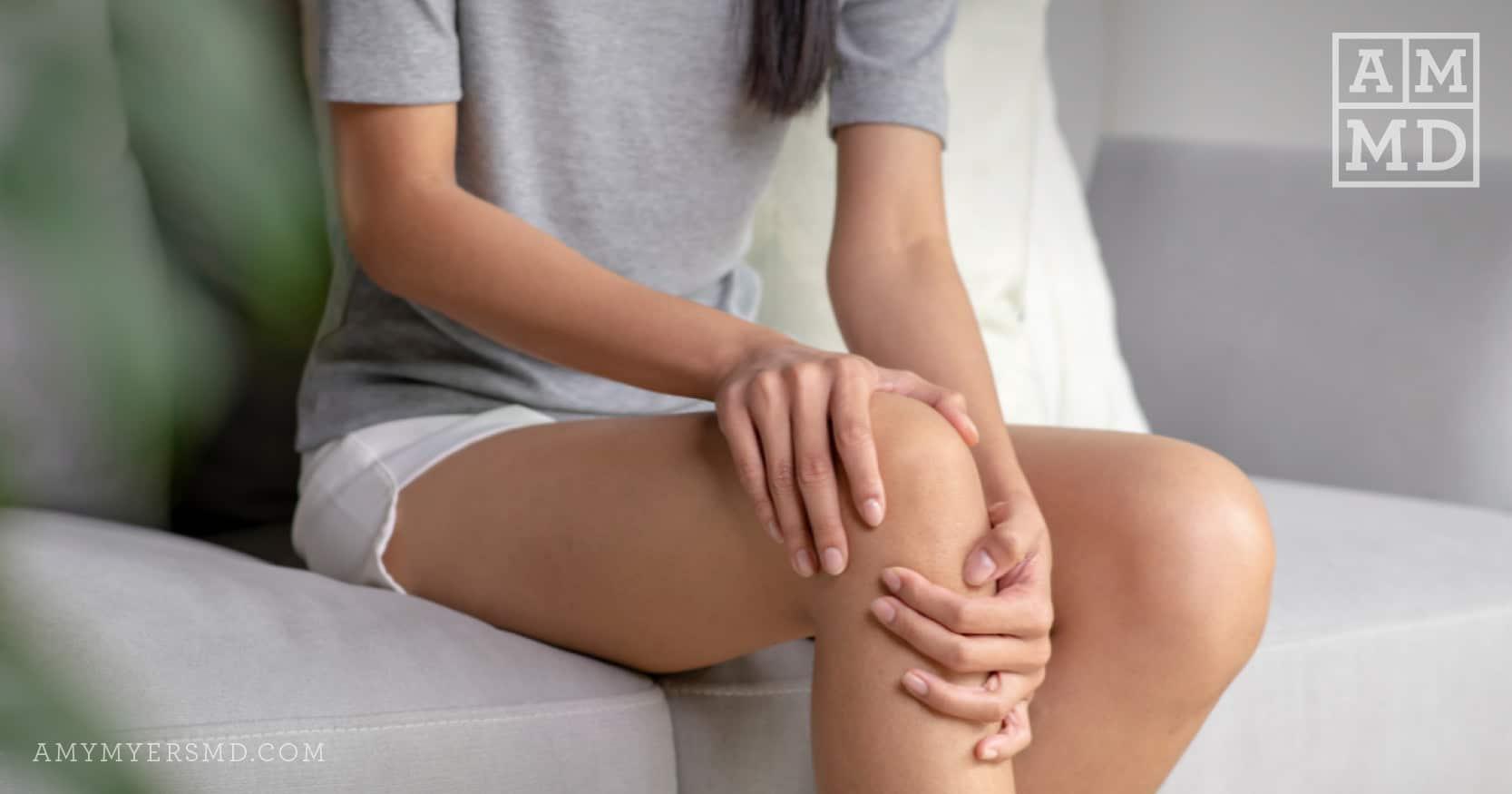 Woman holding knee - Top 5 Sources of Inflammation - Amy Myers MD®