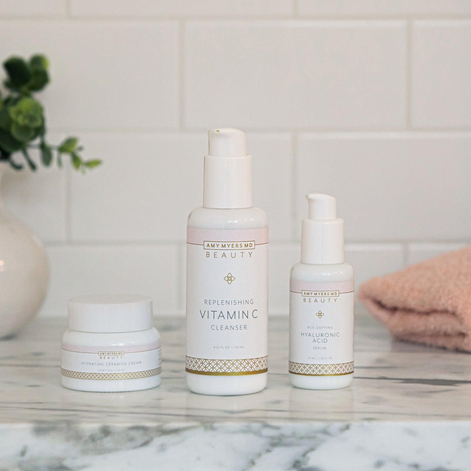 Essential Beauty Kit - Bottles of Replenishing Vitamin C Cleanser,  Hydrating Ceramide Cream, Age-Defying Hyaluronic Acid Serum - Featured Image - Amy Myers MD®