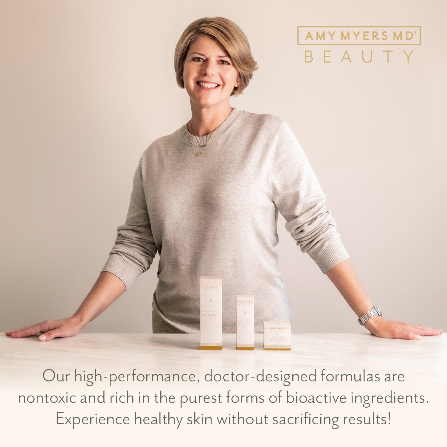 Dr. Amy Myers smiling as she stands behind her beauty and skincare products - Amy Myers MD®