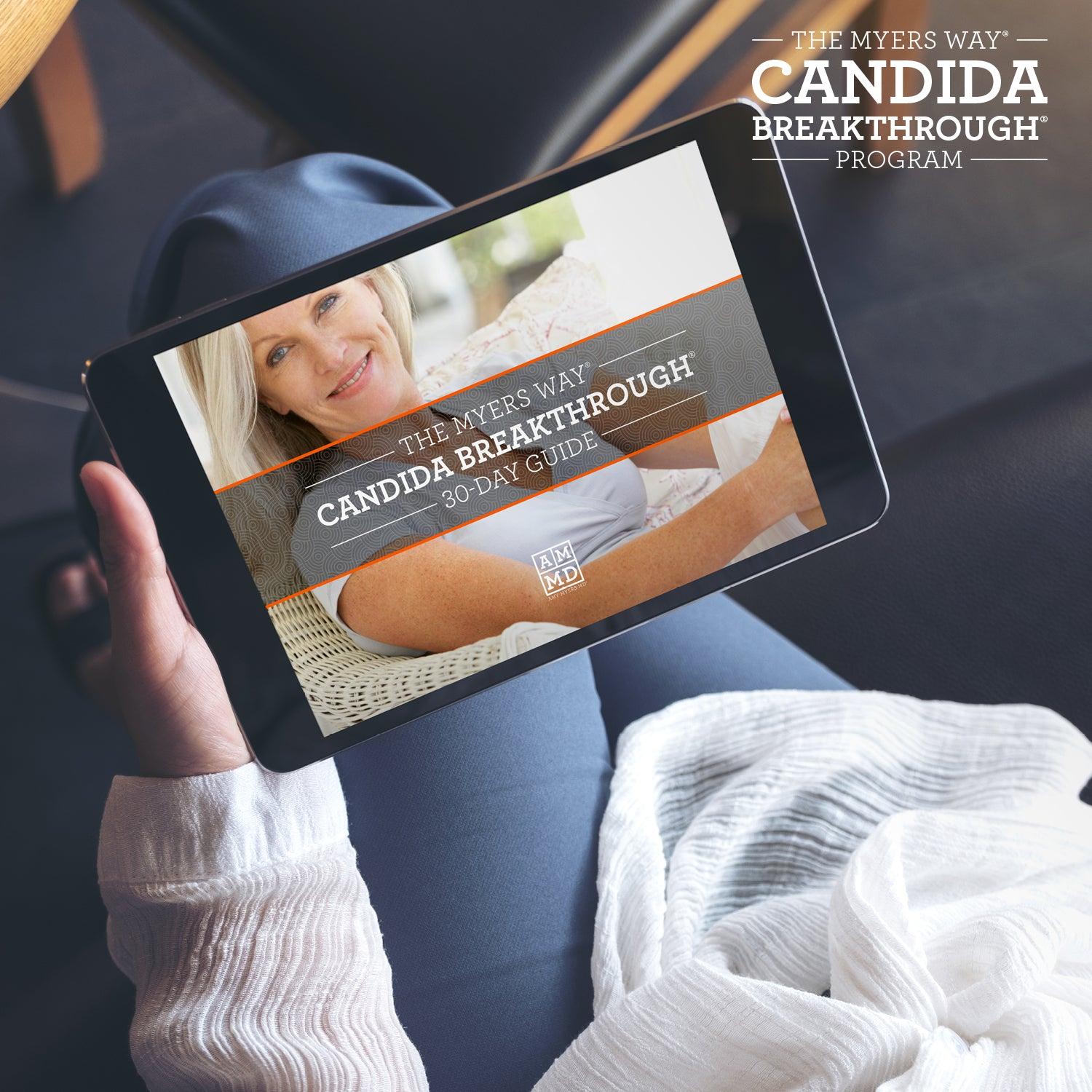 A Woman views The Upgraded Candida Breakthrough Program 30-day Guide on a tablet - Amy Myers MD®