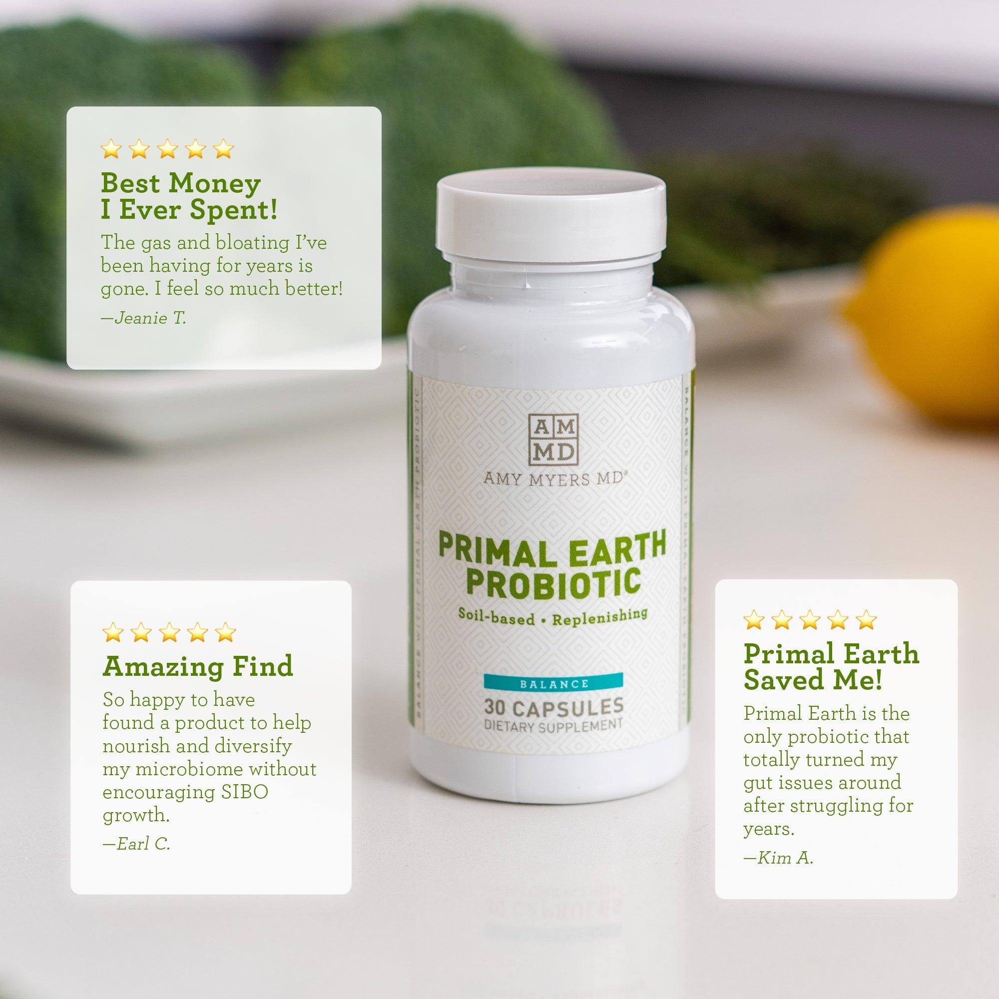 A bottle of Primal Earth Probiotic Supplement on a tabletop with fruits and vegetables, and some reviews - Reviews Image - Amy Myers MD®