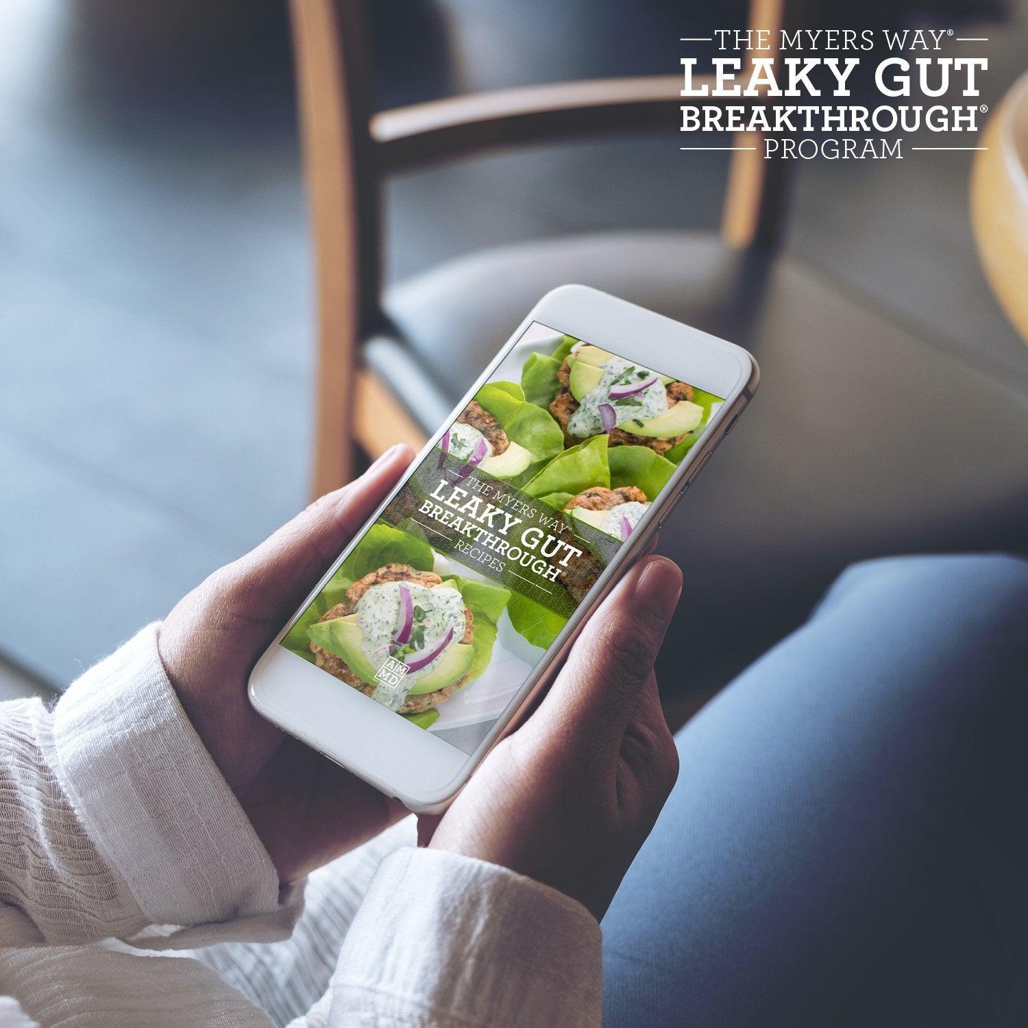 A Woman views The Upgraded Leaky Gut Breakthrough Program Recipes on a smart phone - Amy Myers MD®