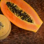 Smoothie next to papaya - Anti-Inflammatory Smoothie Recipe - Amy Myers MD