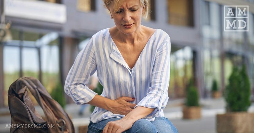 A woman suffering pain due to leaky gut - Featured Image - Amy Myers MD®