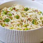 A bowl of keto-friendly, AIP bacon ranch pasta salad topped with pieces of broccoli