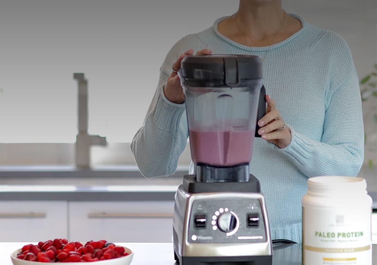 Woman making a smoothie in a blender