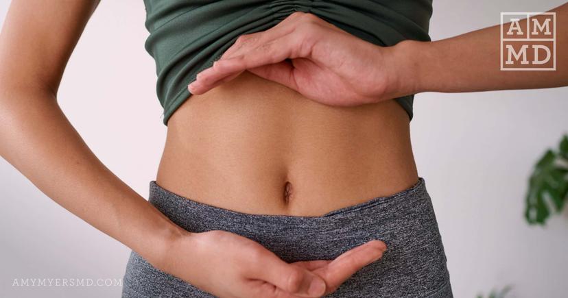 A women touching stomach - Soil-Based (SBO) Probiotics vs. Regular Probiotics - Amy Myers MD