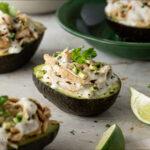 Avocados with stuffing on a table - Stuffed Avocados with Cilantro Cream Sauce- Amy Myers MD®