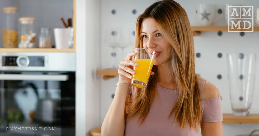 Lady drinking orange juice - What is Liposomal Vitamin C - Amy Myers MD