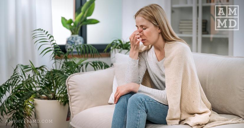 Woman holding nose - Mold and Mycotoxins - Amy Myers MD®