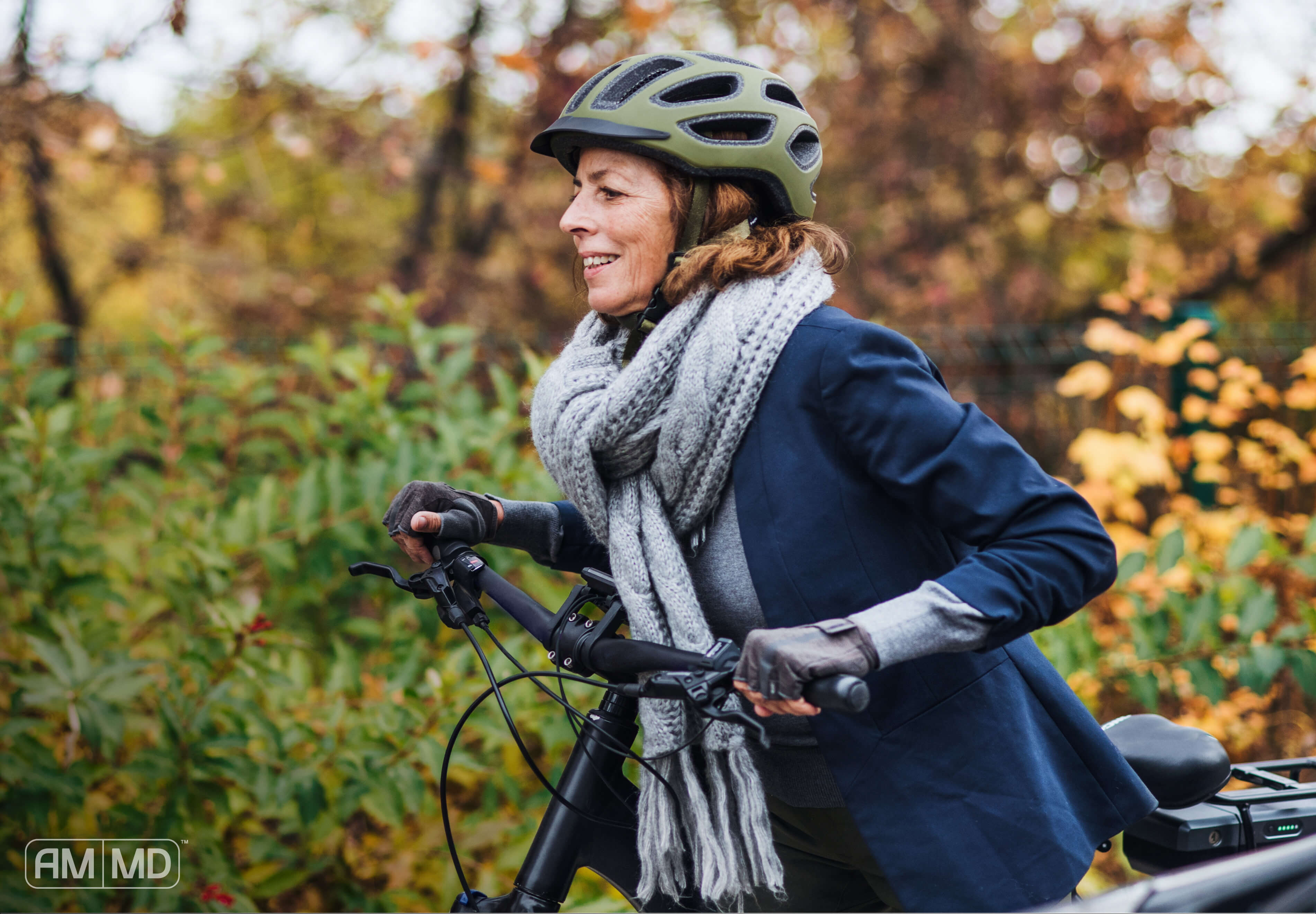 Woman riding a bike in a park with a scarf and jacket on. Article, Women lying on couch holding forhead - 4 Steps to Recover from Chronic Fatigue Syndrome