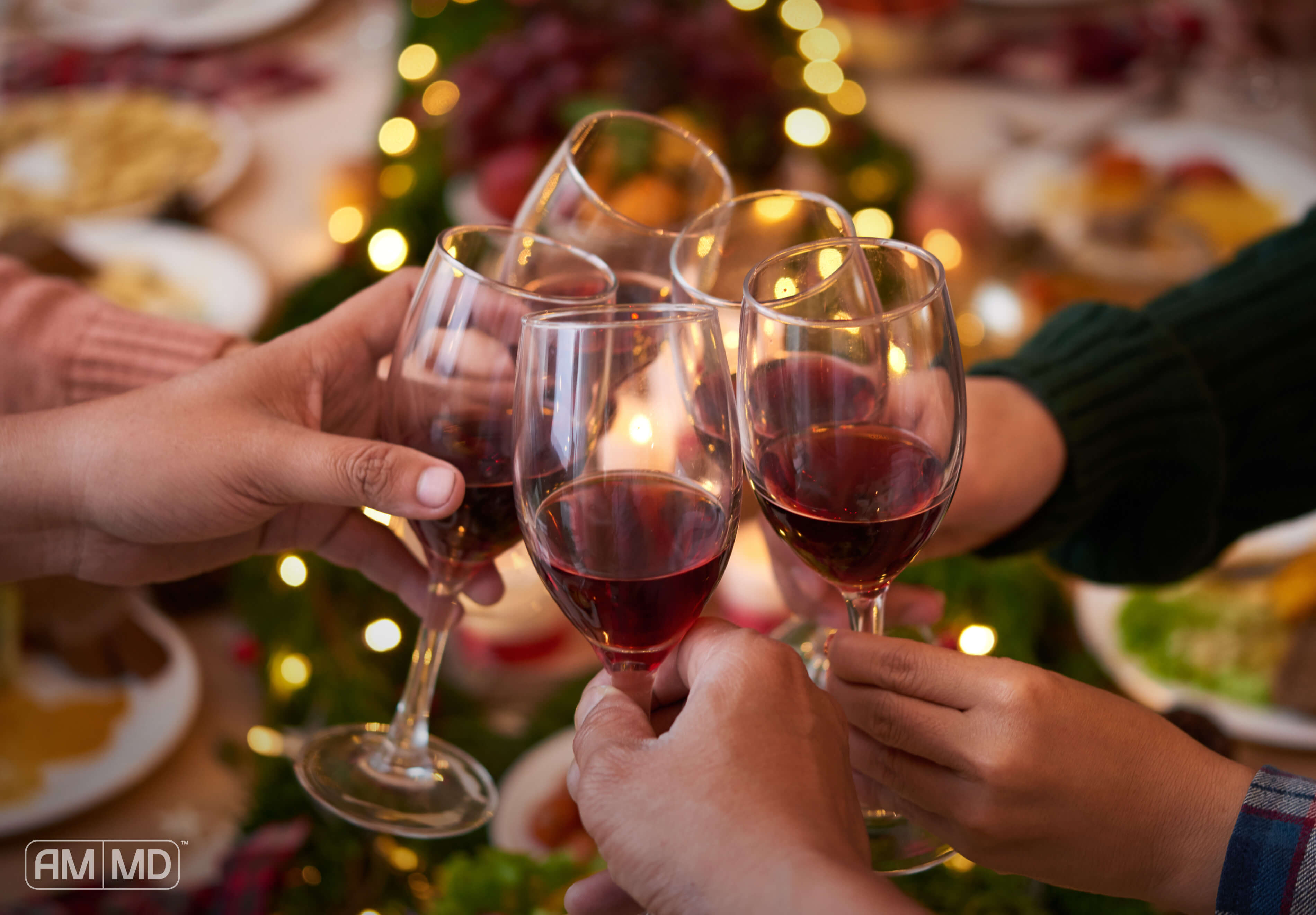 People holding wine glasses over a table full of food cheers, How To Get Alcohol Out Of Your System 