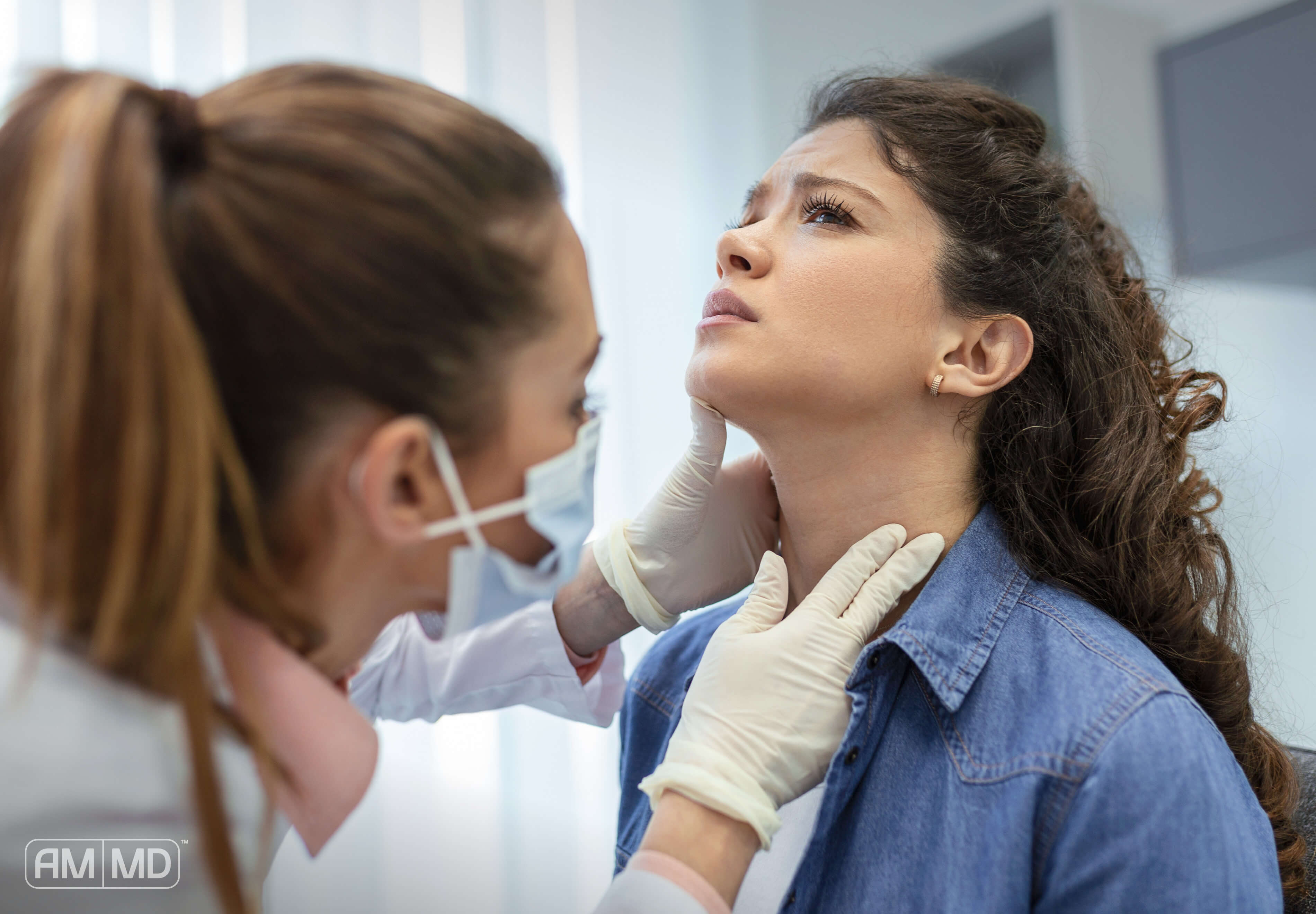 Doctor checking woman's thyroid - Is Hypothyroidism an Autoimmune Disease? - AMMD™
