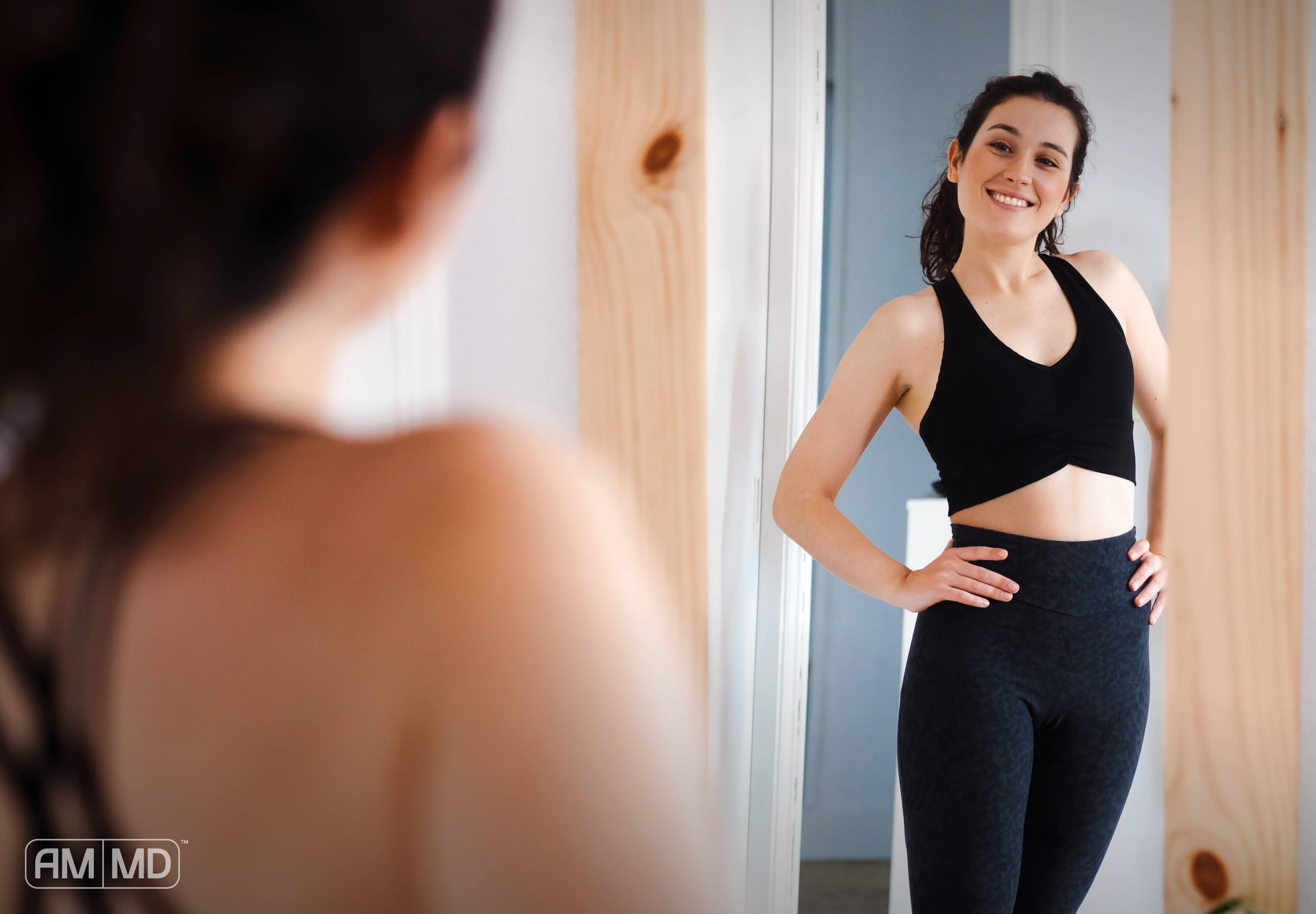 Woman looking in the mirror at herself. Article, The Broad Spectrum of L-Glutamine Benefits