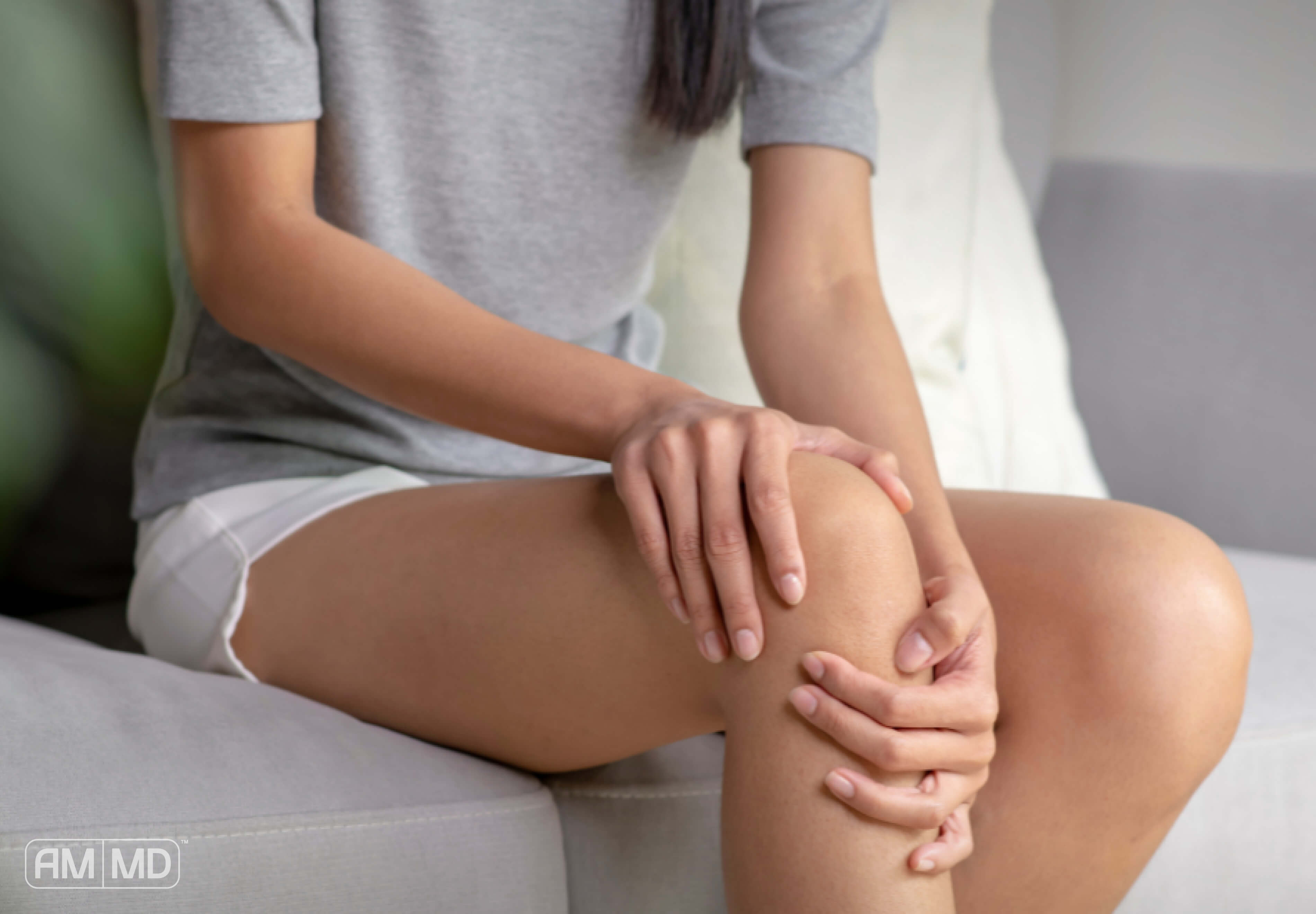 Woman holding her knee.  Article, The Top 5 Sources of Inflammation
