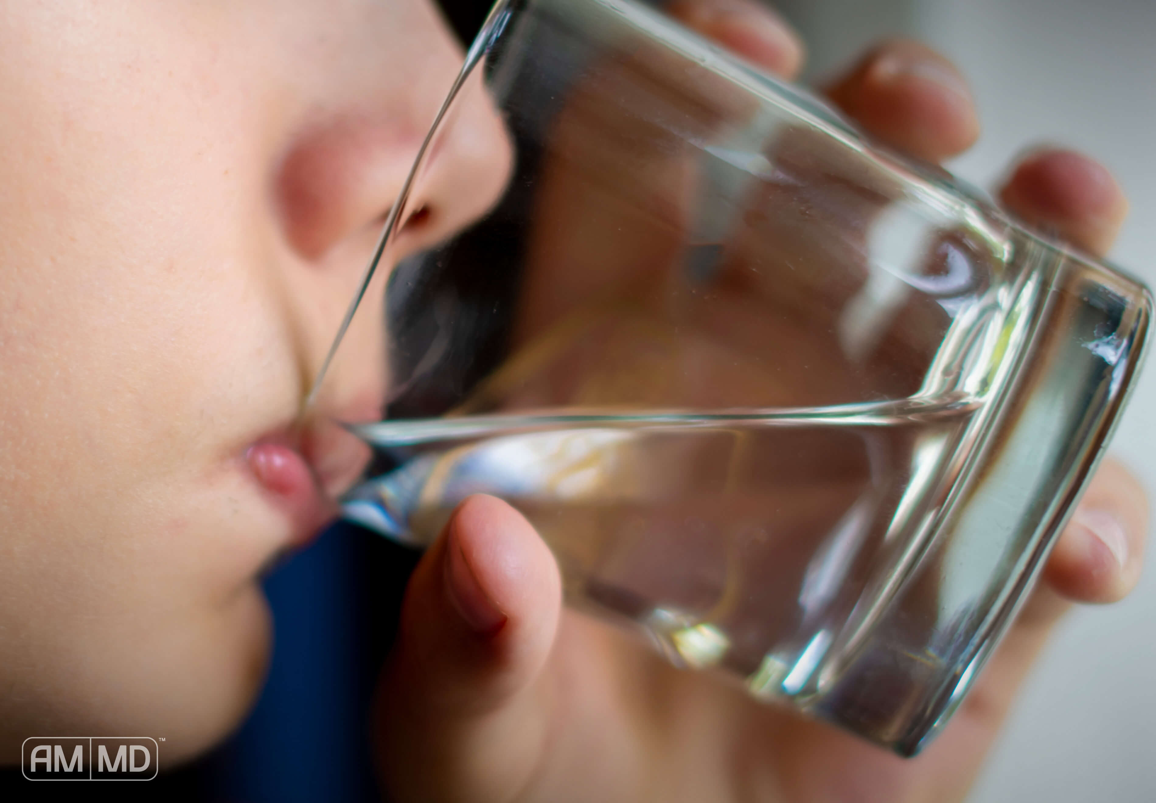 Child sipping water from a glass - The Toxin, Heavy Metal & Thyroid Connection - Amy Myers MD®