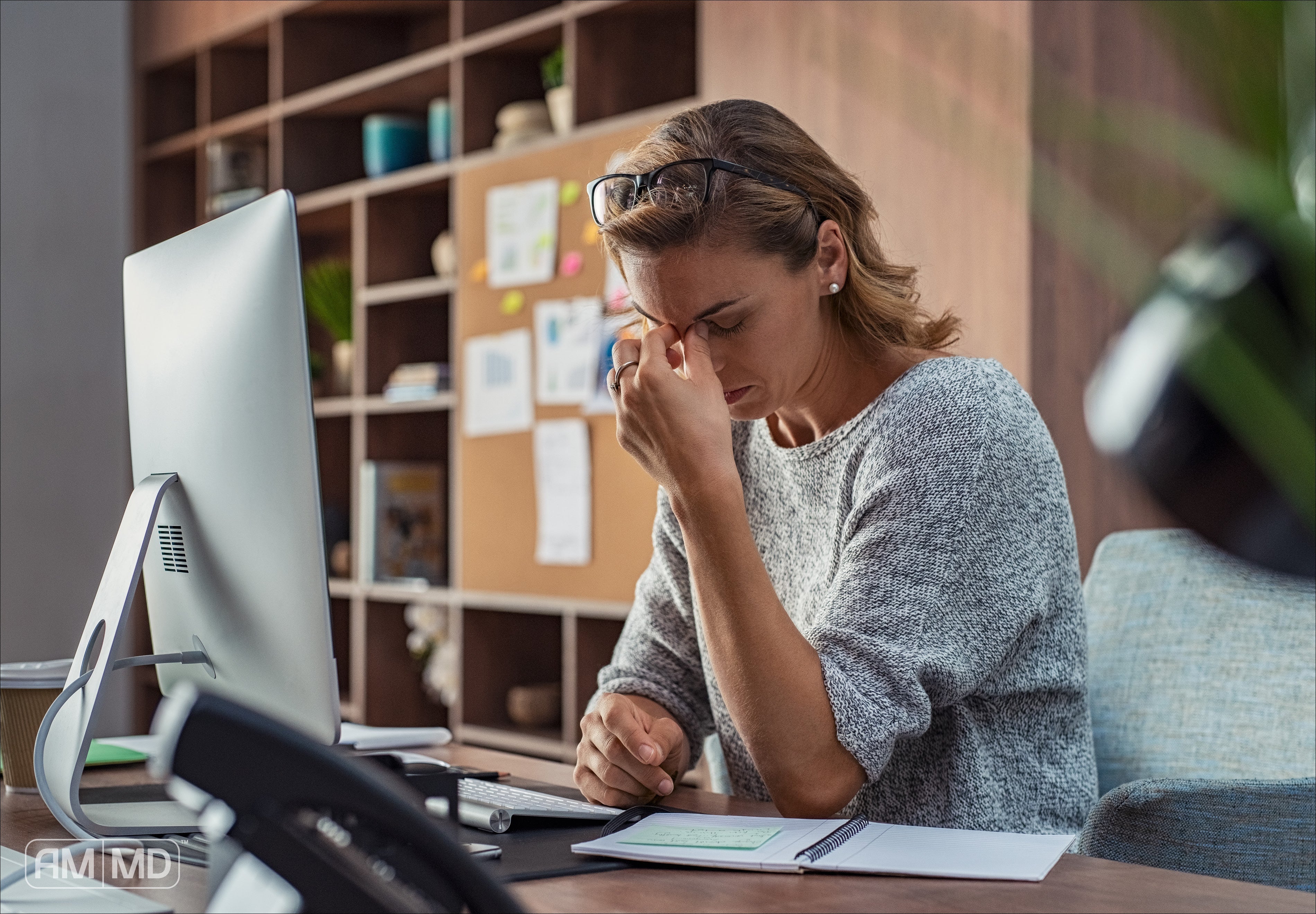 Woman holding forehead - What Are Die Off Symptoms & How To Reduce It - AMMD™