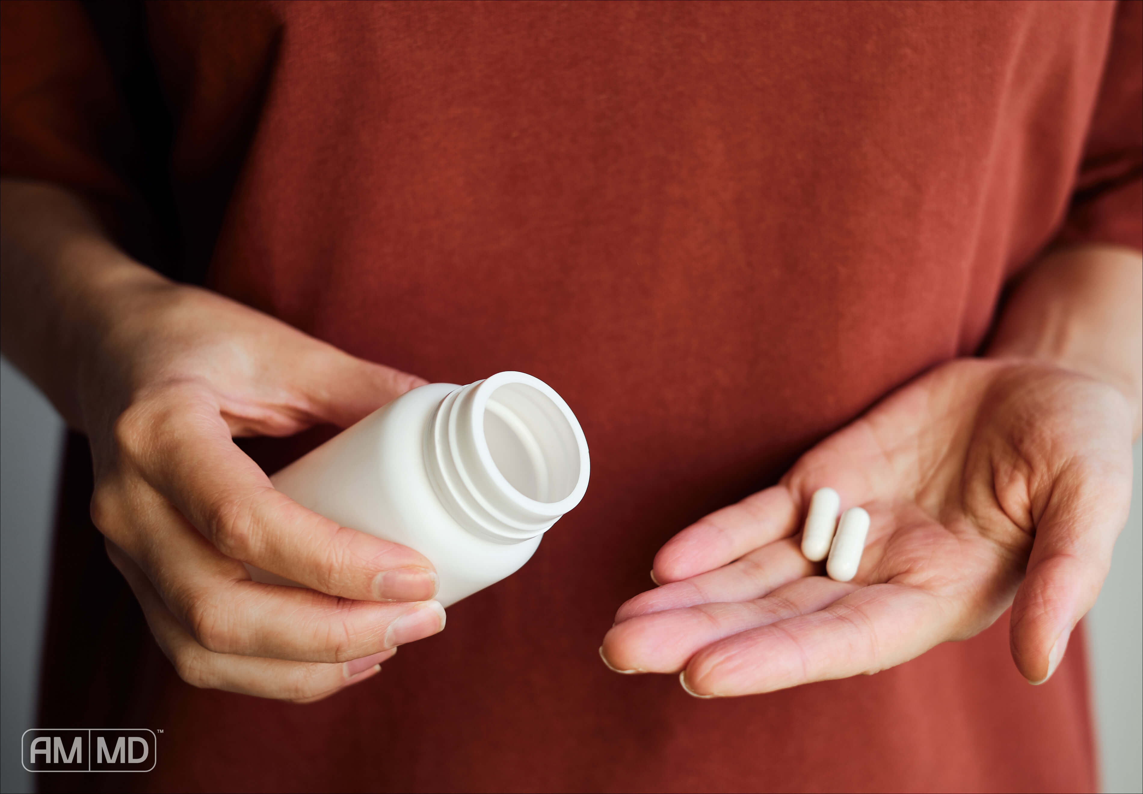 Pouring probiotics into palm - What Happens When You Stop Taking Probiotics? - AMMD™