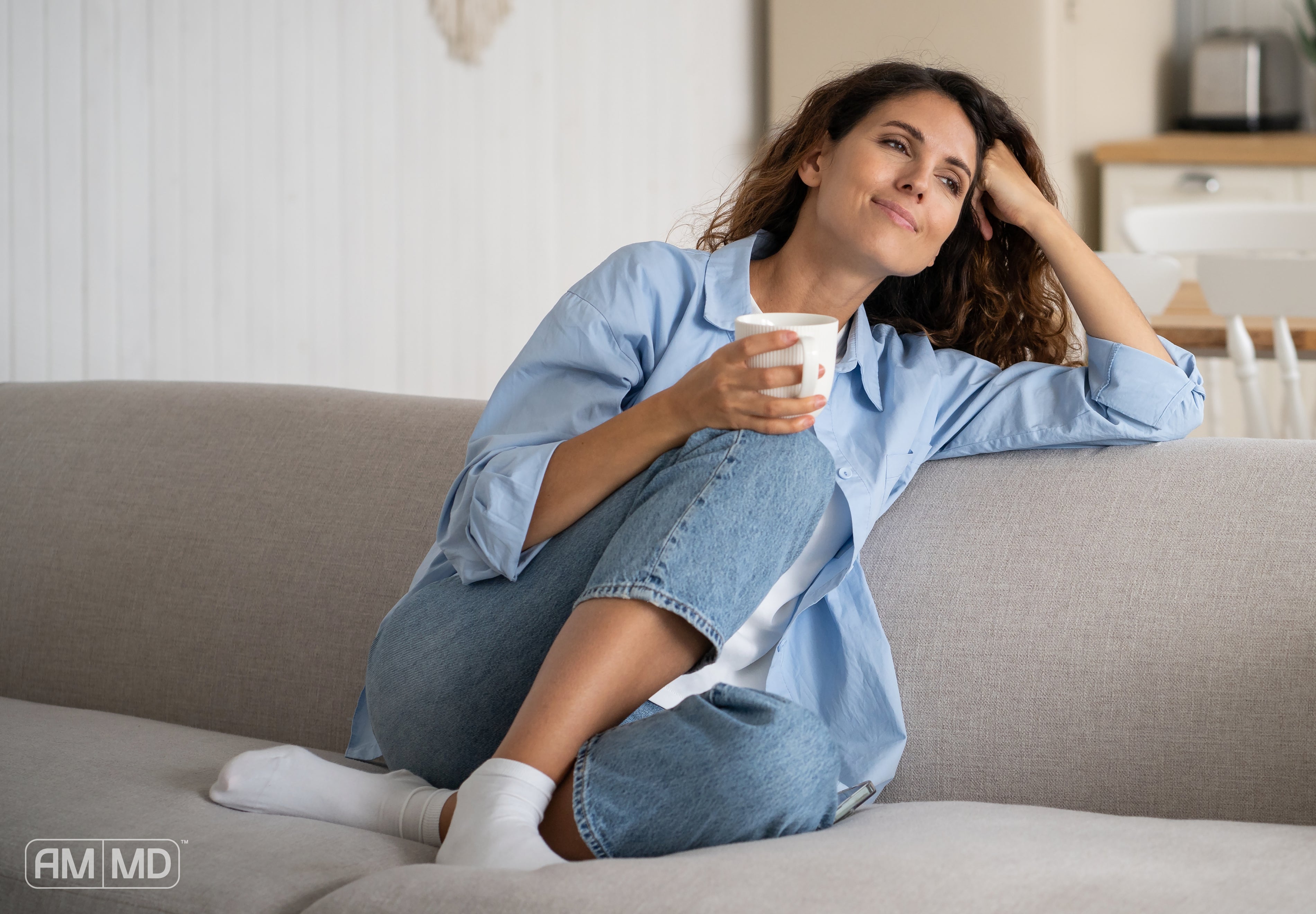 Woman sitting on the couch - 7 Holistic Ways to Improve Mental Health and Feel More Like Yourself - AMMD™