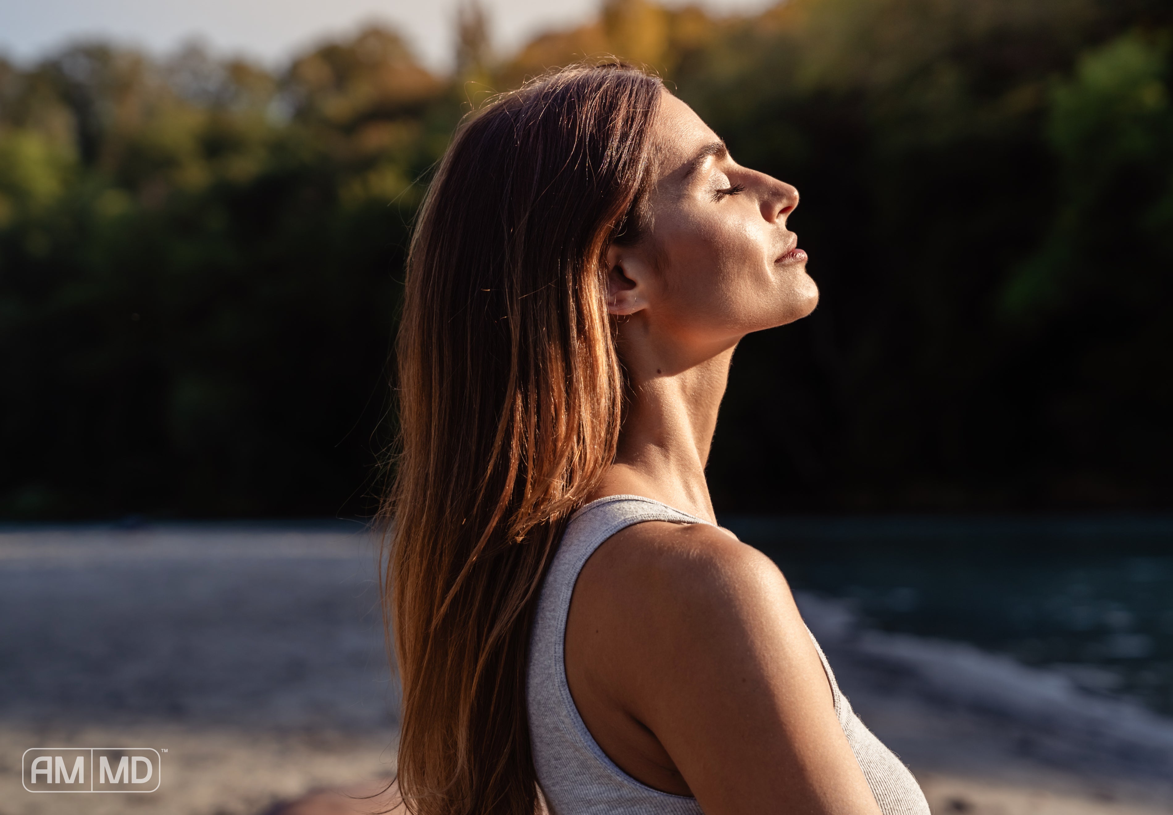 Woman enjoying the sun - Calcium and Vitamin D: Essentials for Strong Bones - AMMD™
