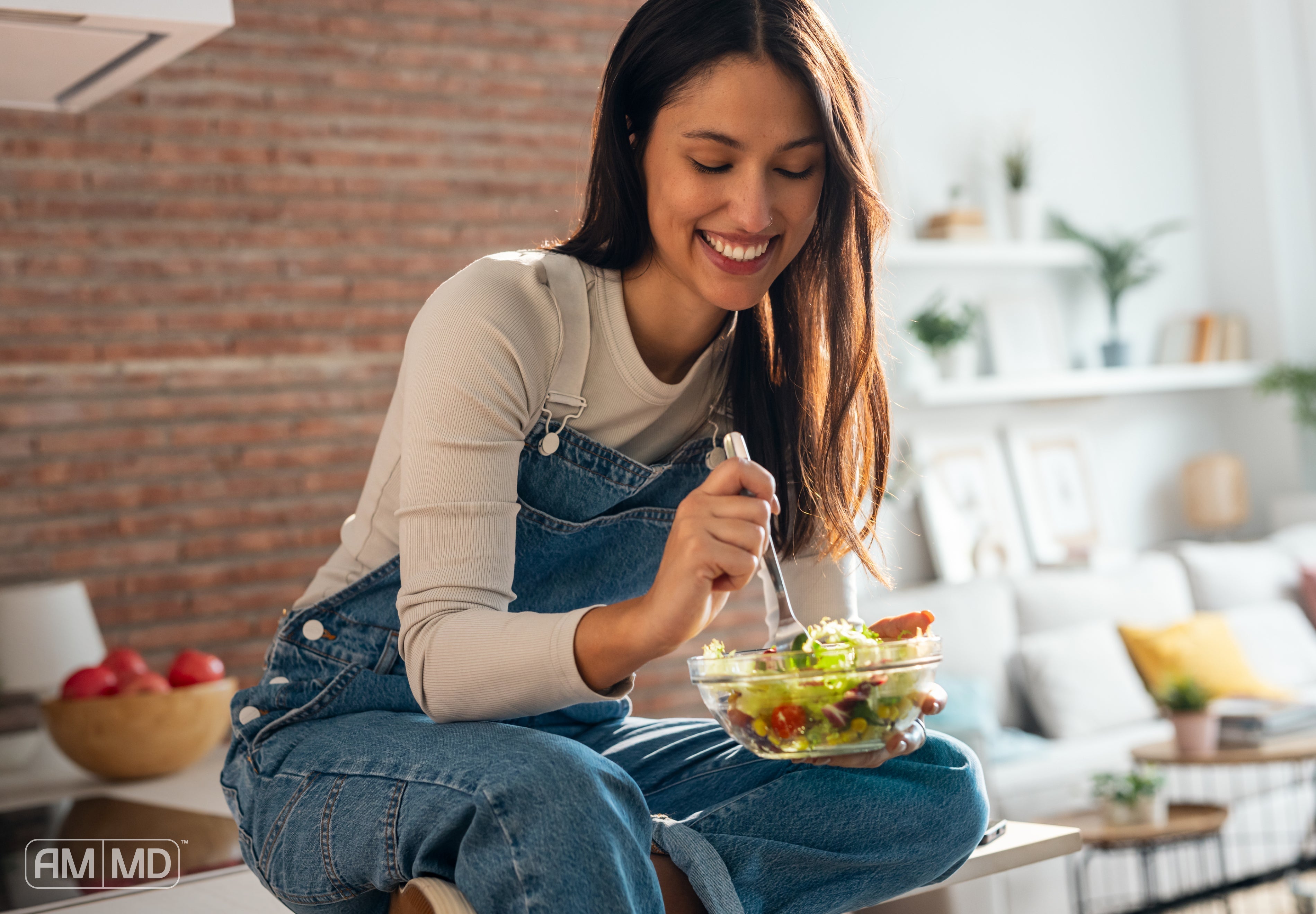 Woman eating a salad - Candida Cleanse Detox: Tips for an Effective Cleanse - AMMD™