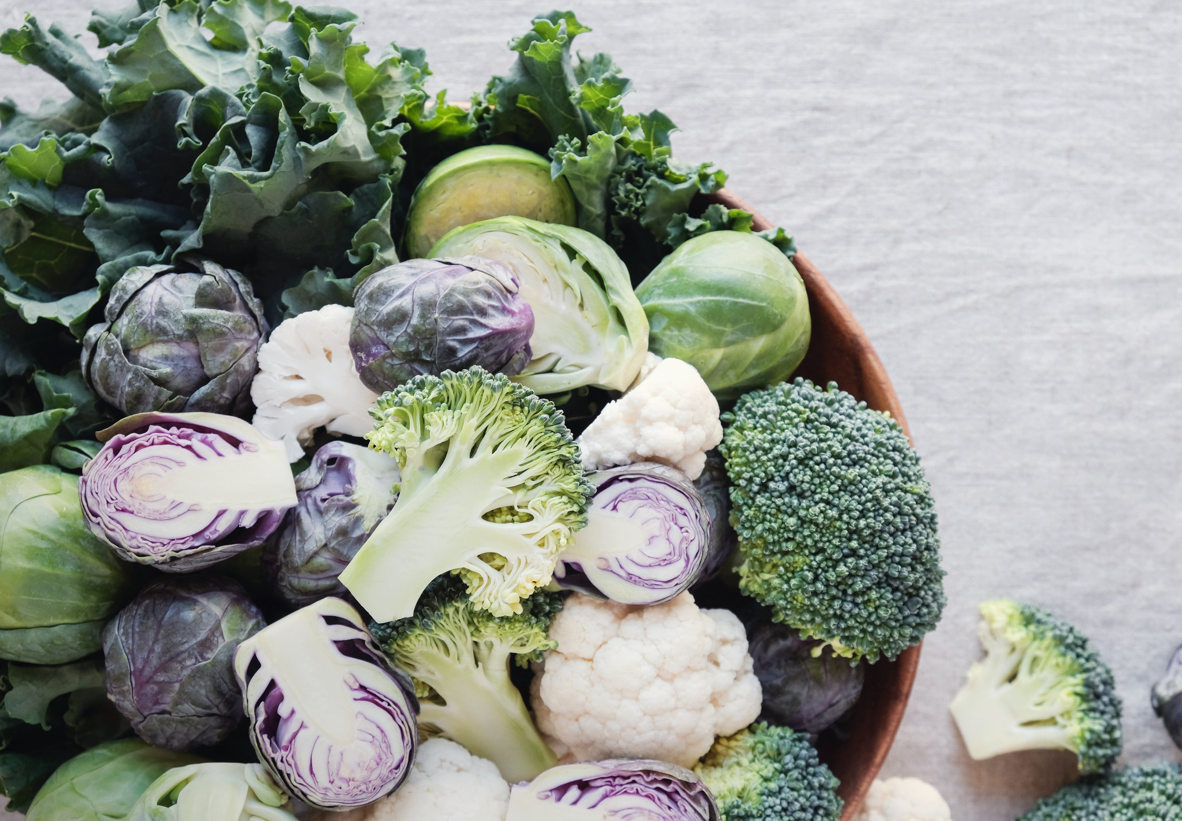 Bowl of cruciferous vegetables including broccoli, kale, cabbage, and Brussels sprouts for thyroid health