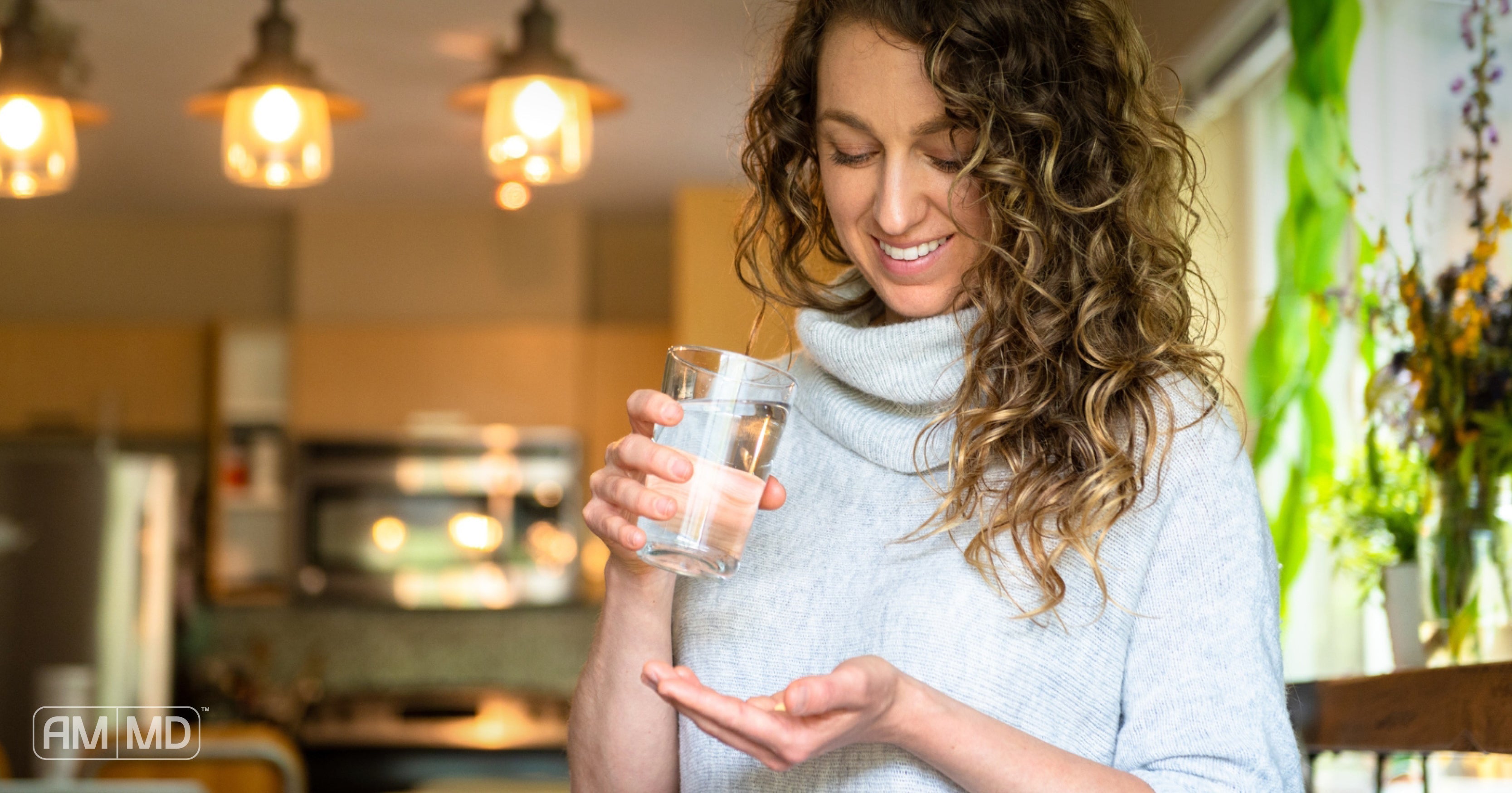 Woman taking a multivitamin - Do You Need a Multivitamin? - AMMD™