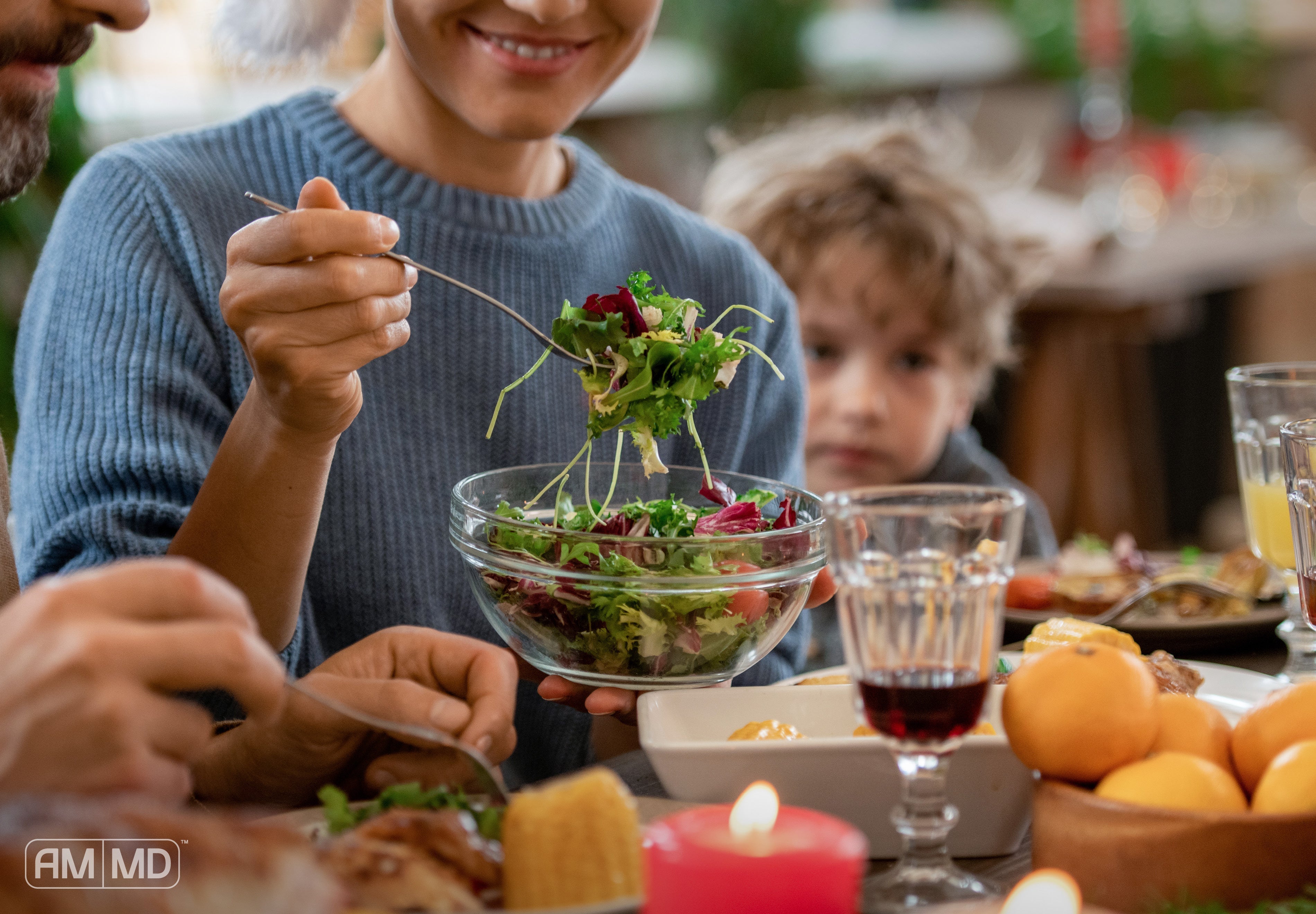 Woman eating a salad - Eating Healthy During The Holidays - AMMD™