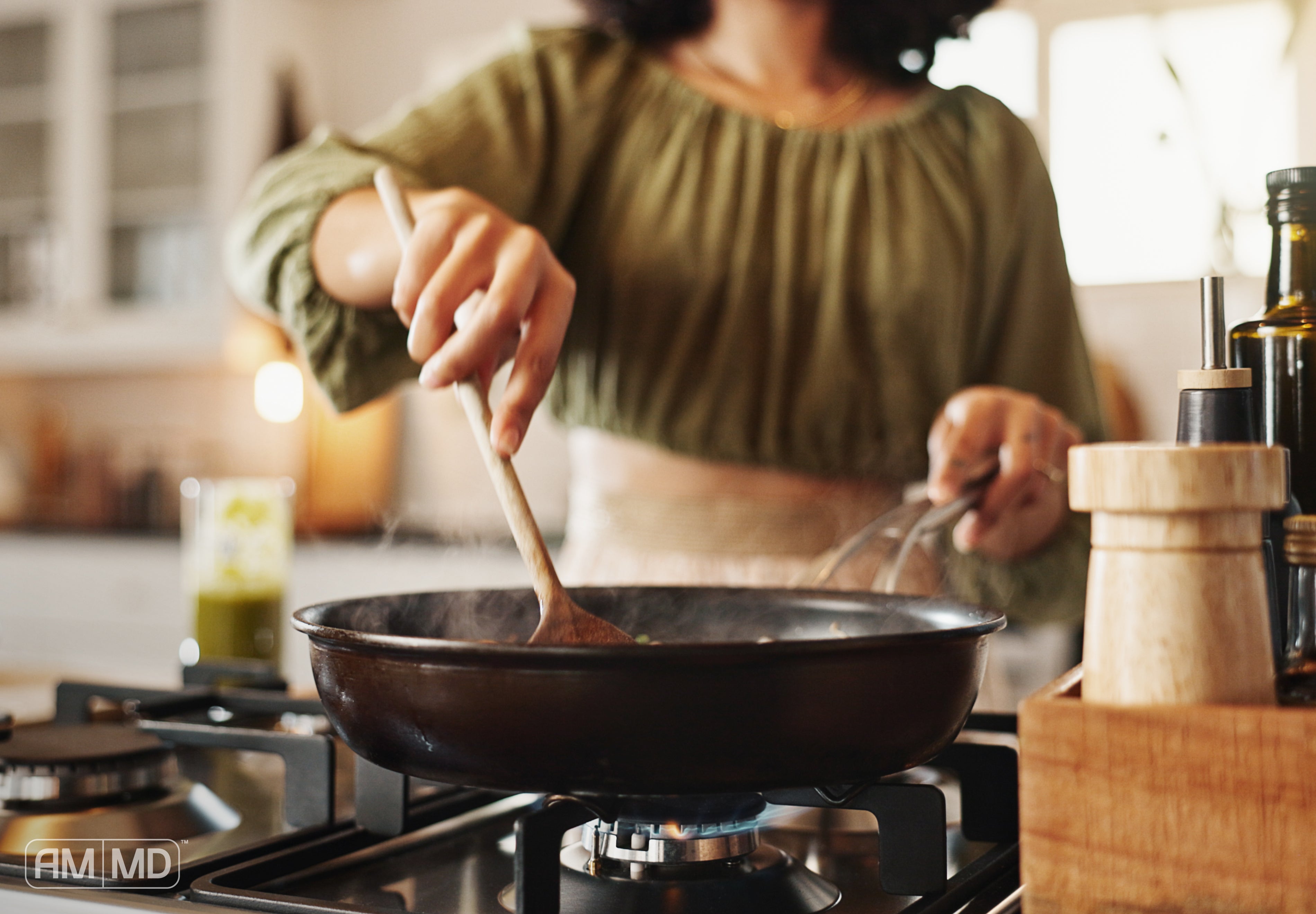 Woman cooking - Endocrine Disruptors List: 12 Everyday Sources That May Affect Breast Health - AMMD™