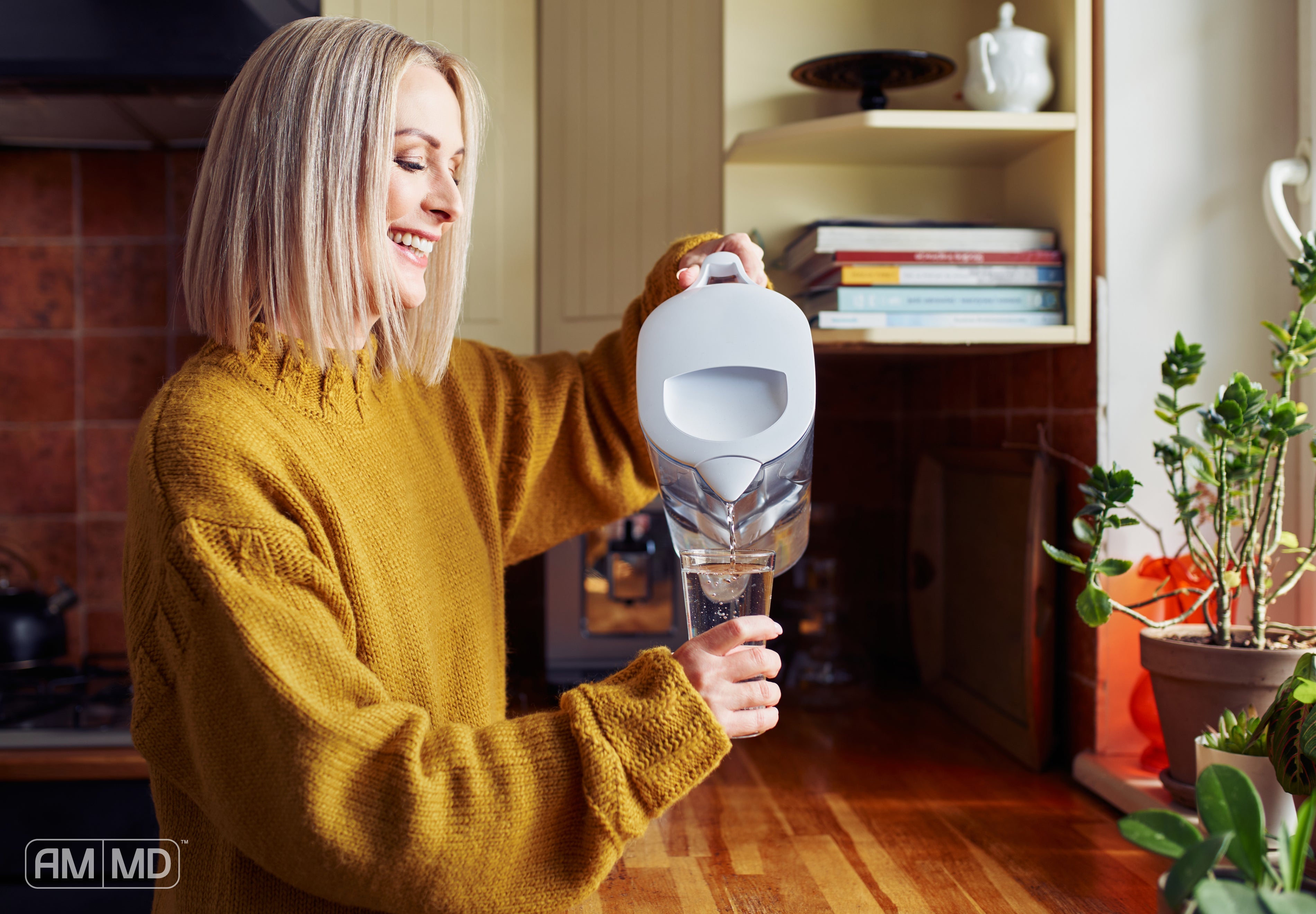 Woman pouring water into a glass - Estrogen Metabolism and Breast Cancer: Why Detox Pathways Matter - AMMD™
