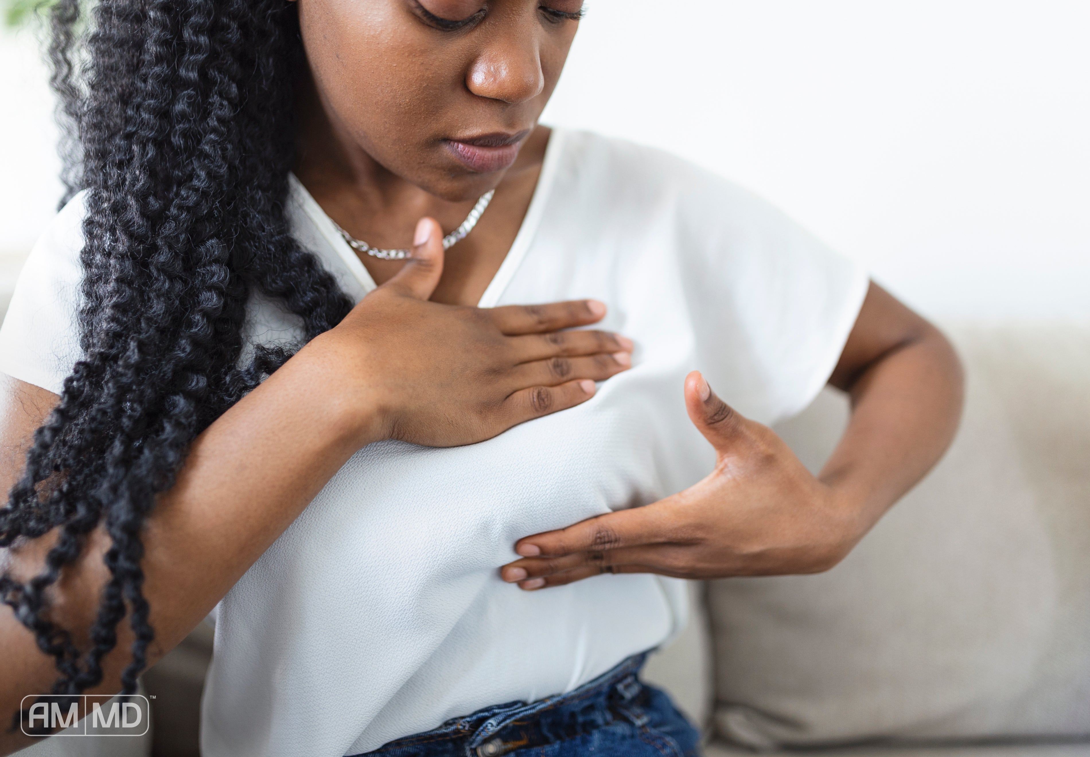 Women self examining breast - Everything You Need To Know About Dense Breast Tissue - AMMD™