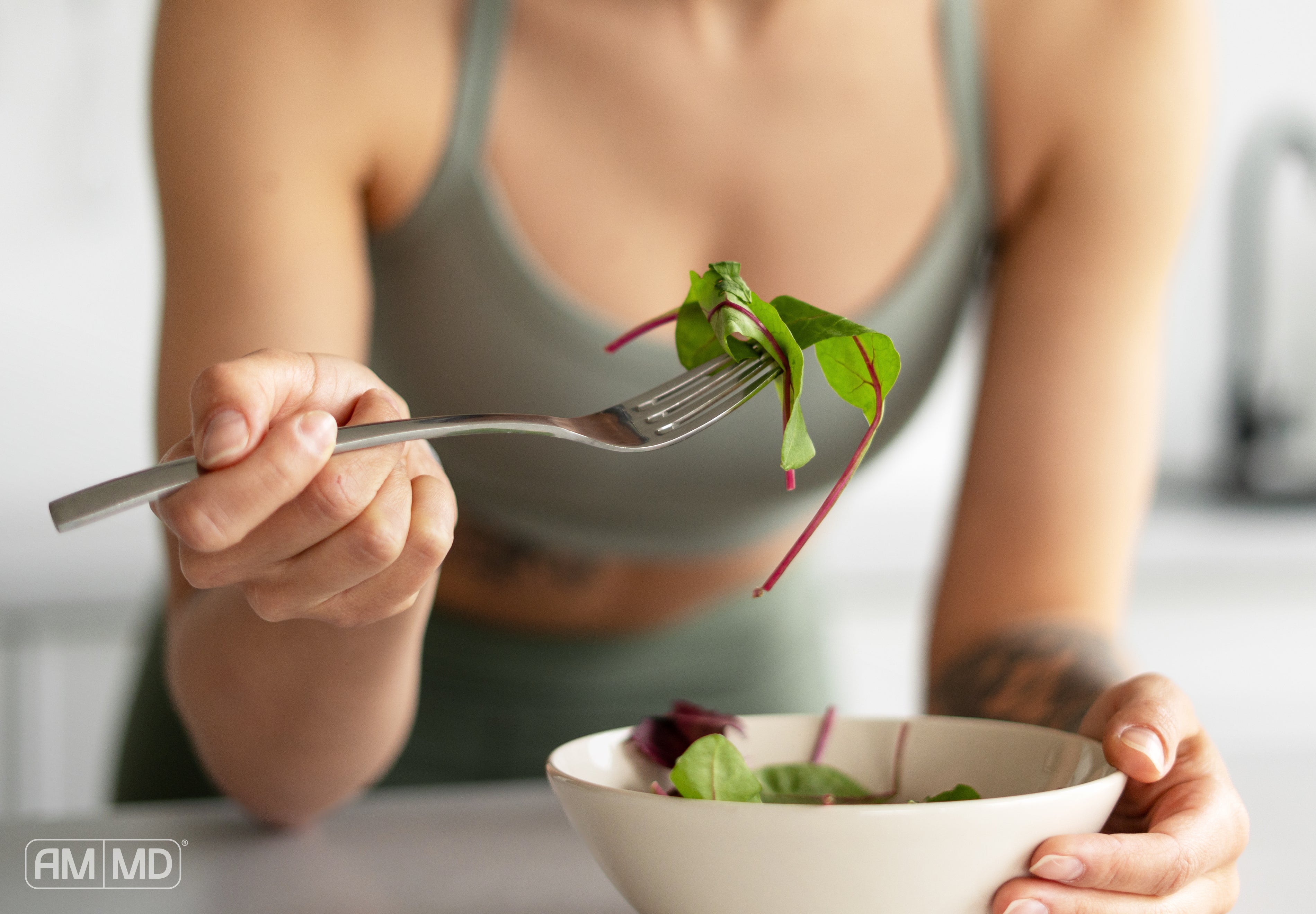 Woman eating salad - Fixing Leaky Gut: Avoid These 10 Mistakes - AMMD™