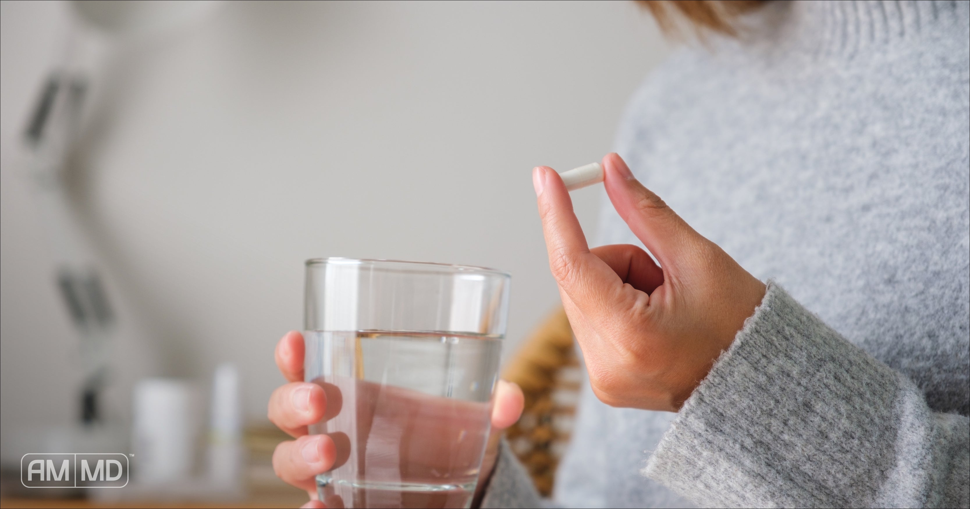 Woman holding capsule - Glutathione – The #1 Nutrient for Detoxification - AMMD™