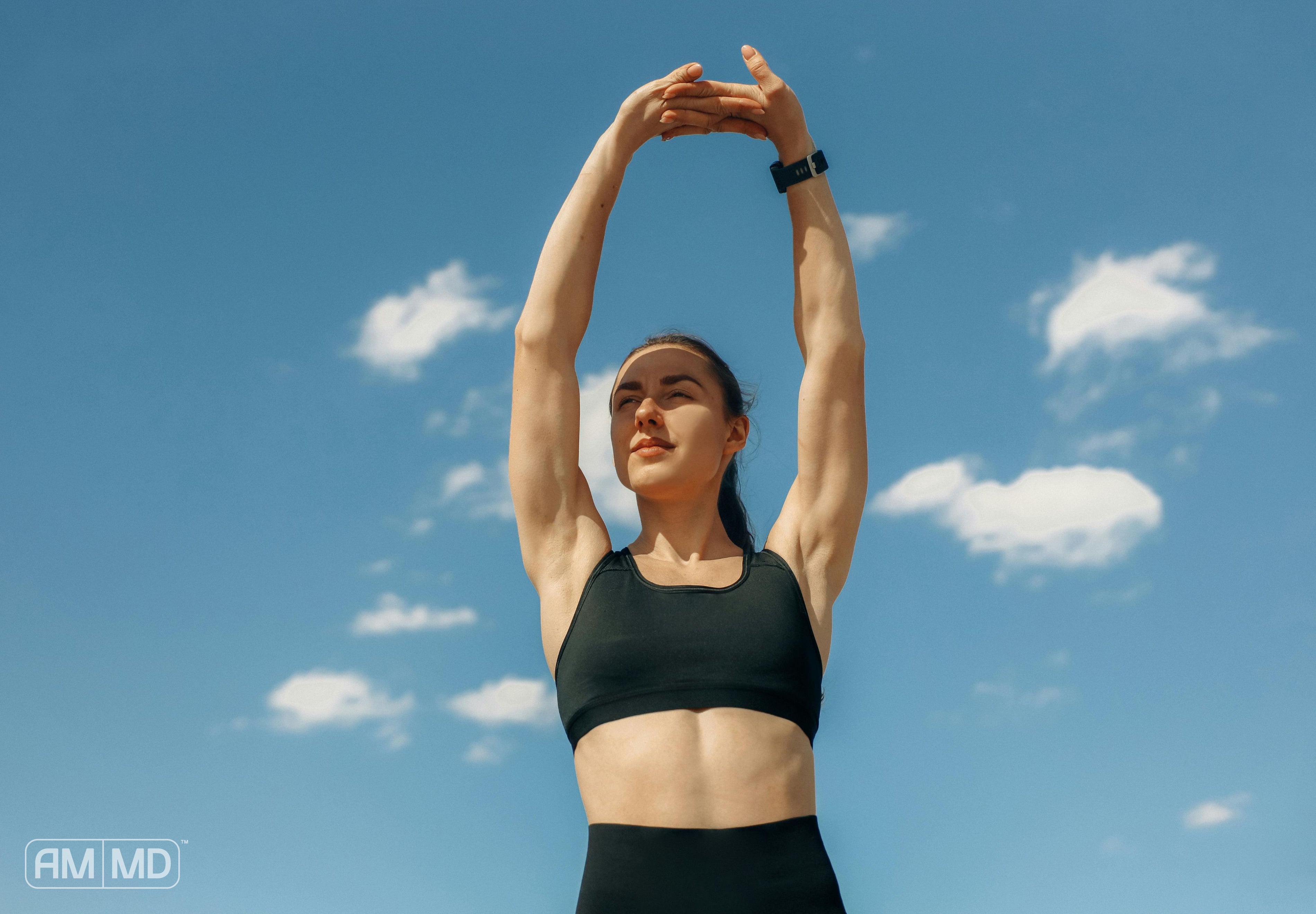 Woman stretching outside - How to Get Energy Without Caffeine: 6 Tips - AMMD™