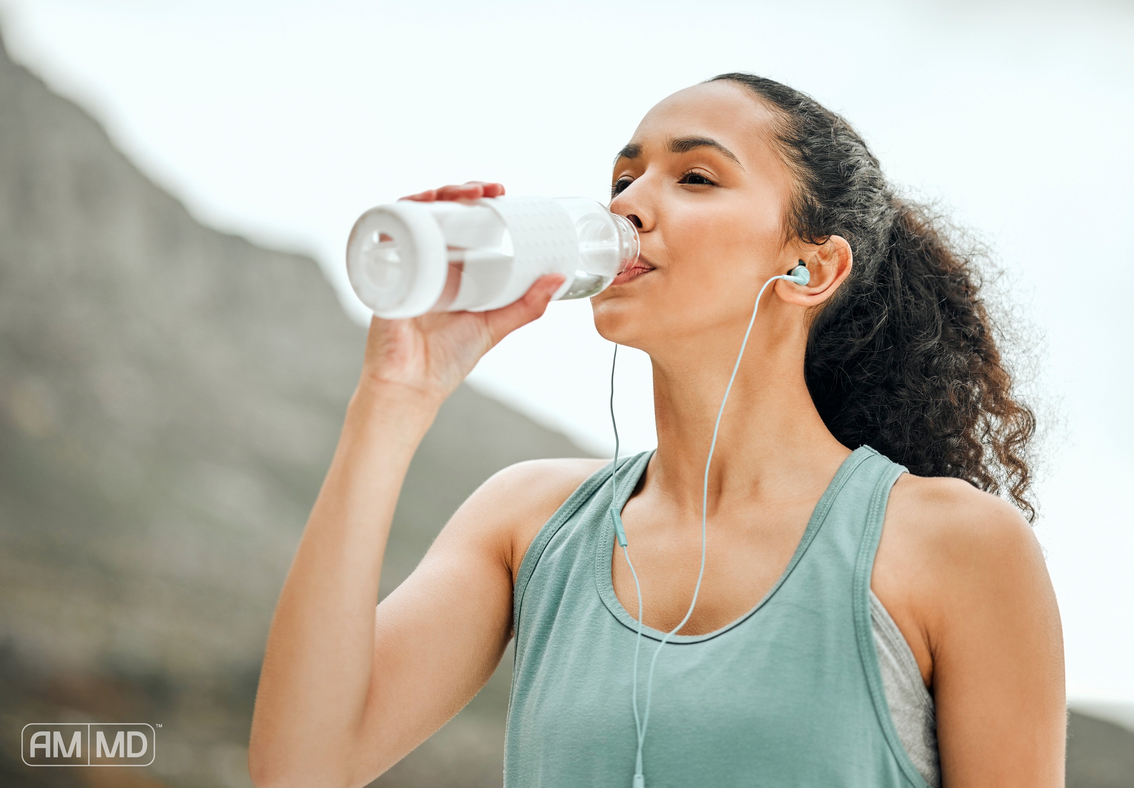 Woman drinking water - How to Make Your Immune System Stronger - AMMD™