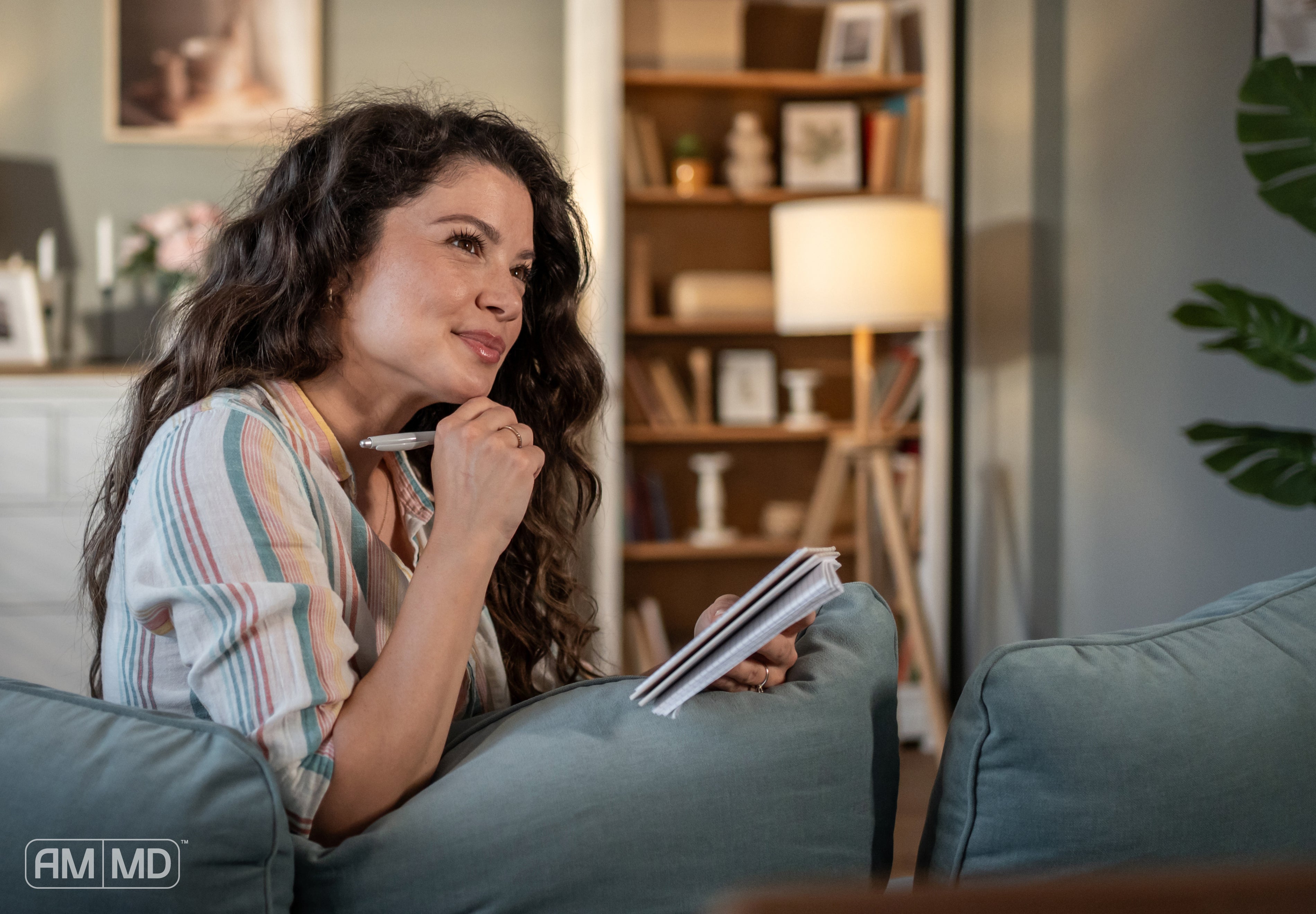 Women sitting on the couch writing on a notepad - Inflammation and the Functional Medicine Approach: 7 Key Strategies - AMMD™