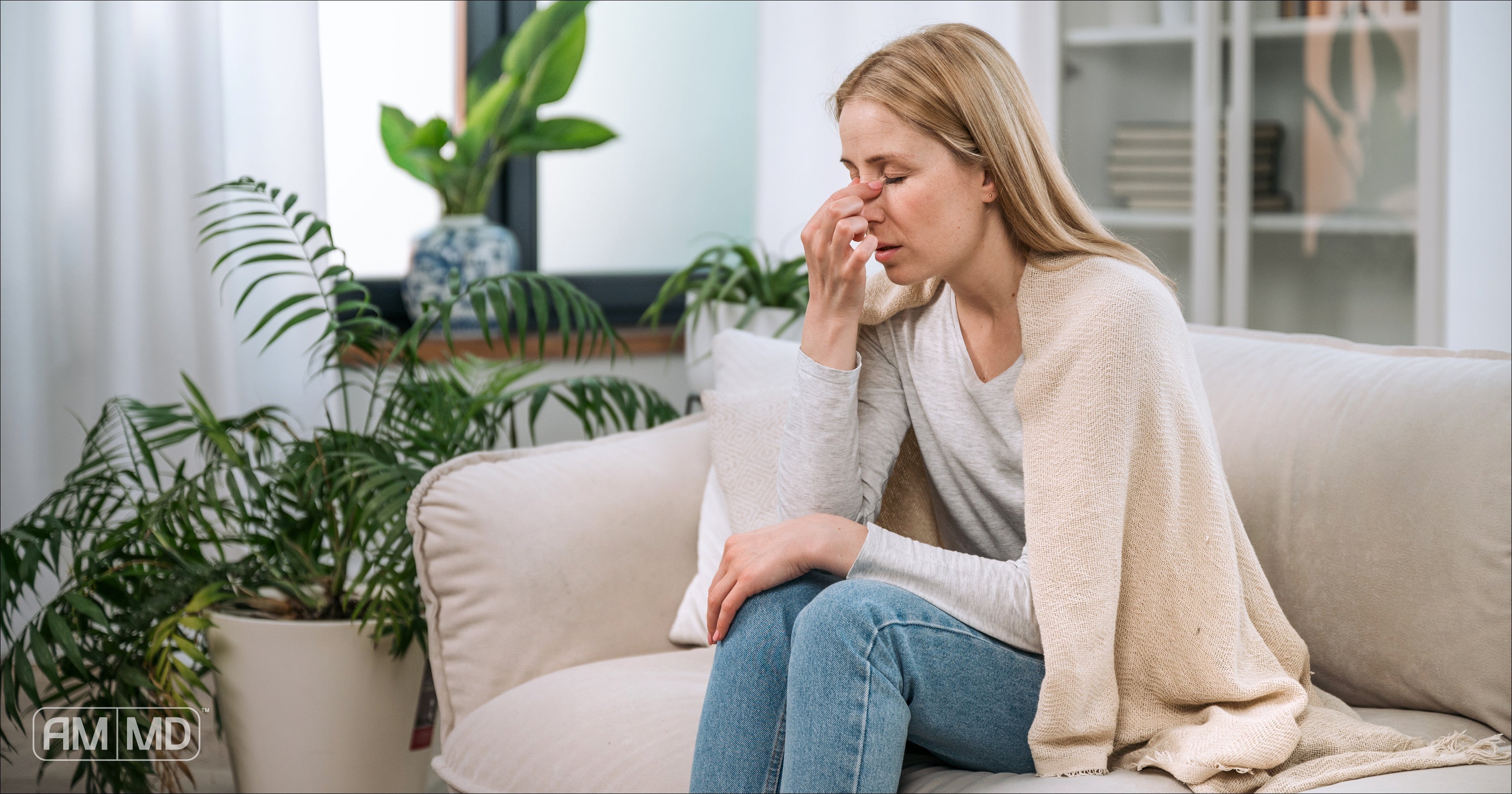 Woman holding nose - Mold and Mycotoxins: Symptoms & Solutions - Amy Myers MD®