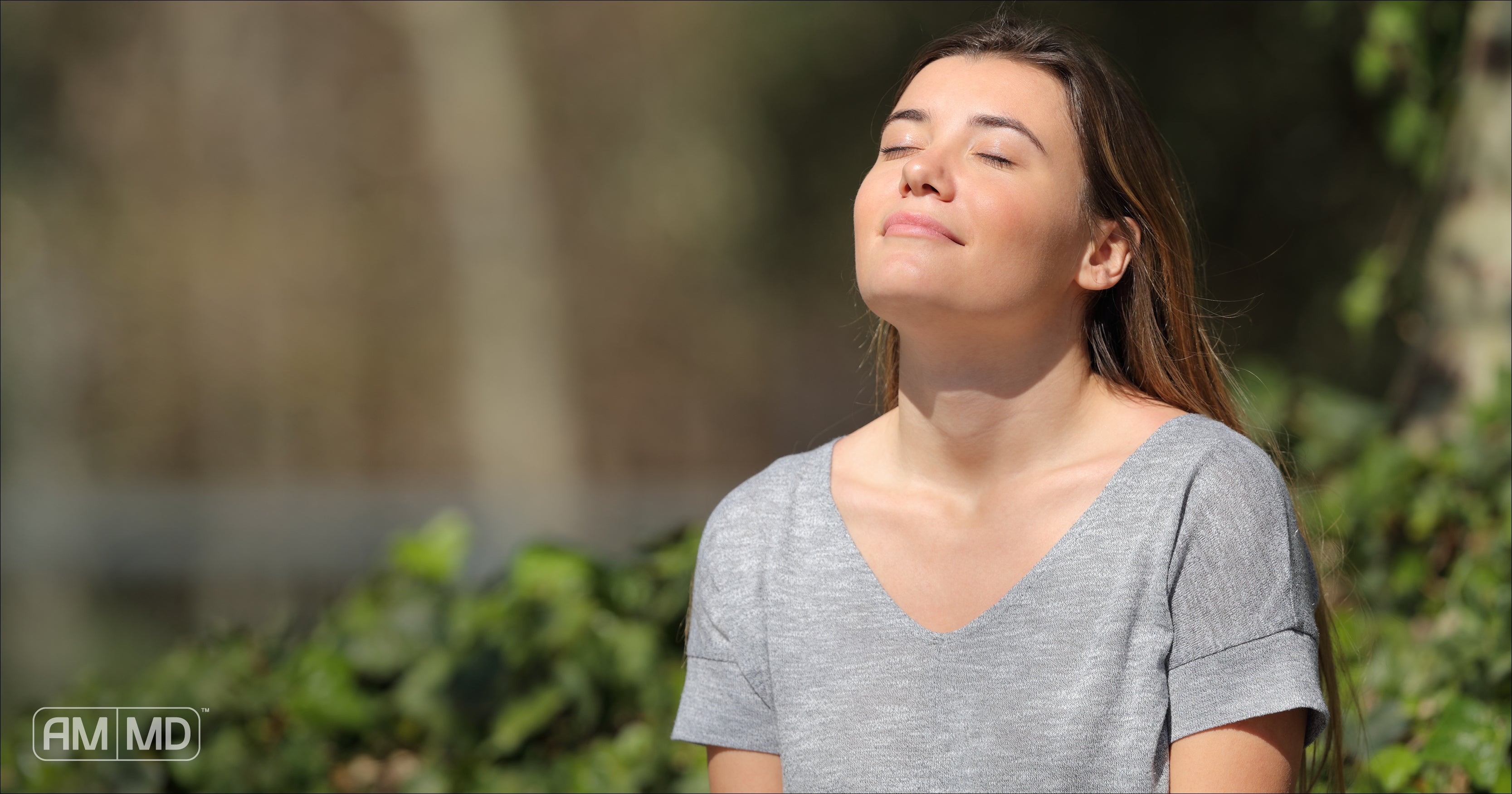 Woman standing in the sun feeling relaxed - Serotonin & The Gut: The Gut-Brain Axis - AMMD™