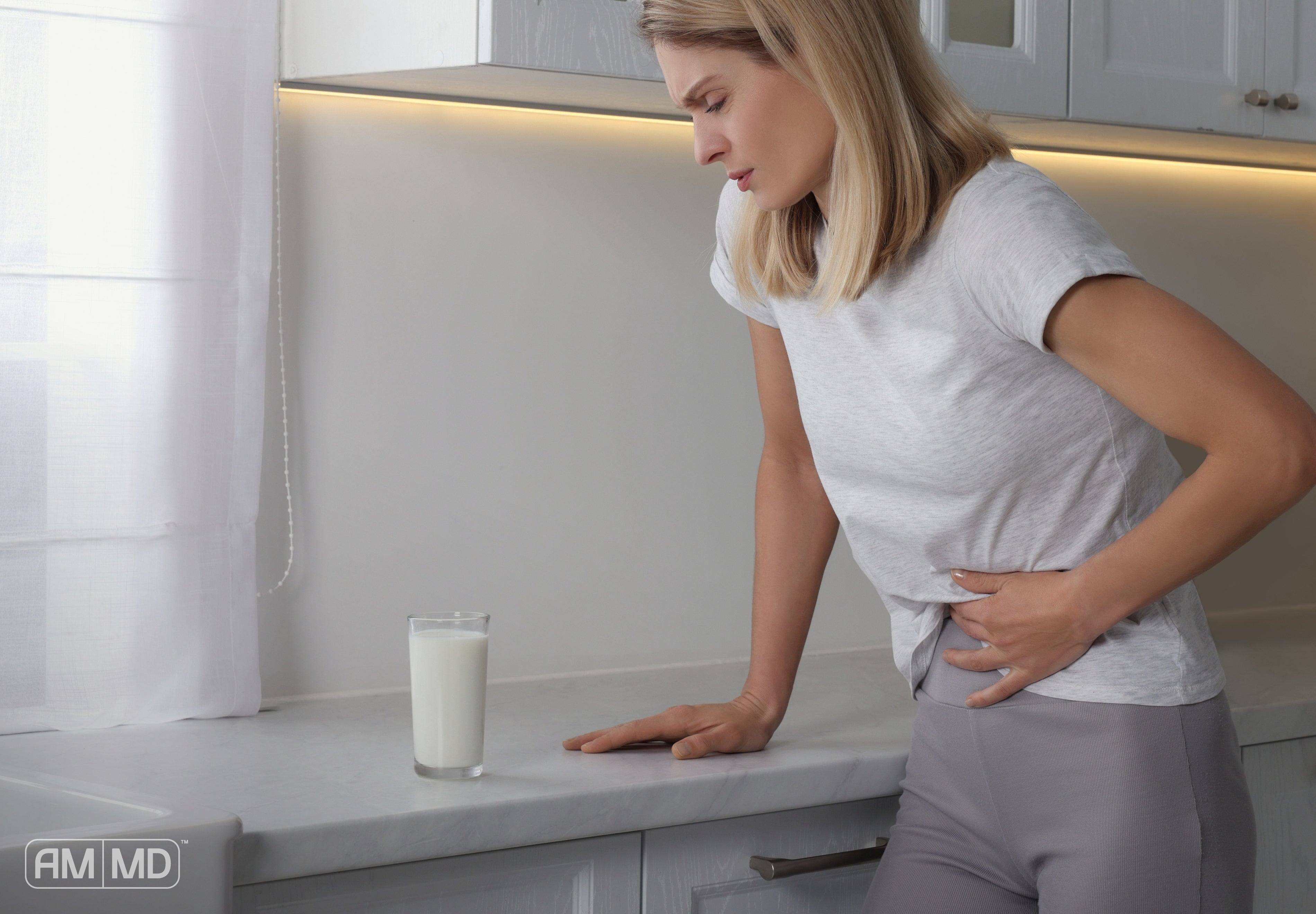Two Surprising Causes of Leaky Gut - Woman suffering from abdominal pain - AMMD™