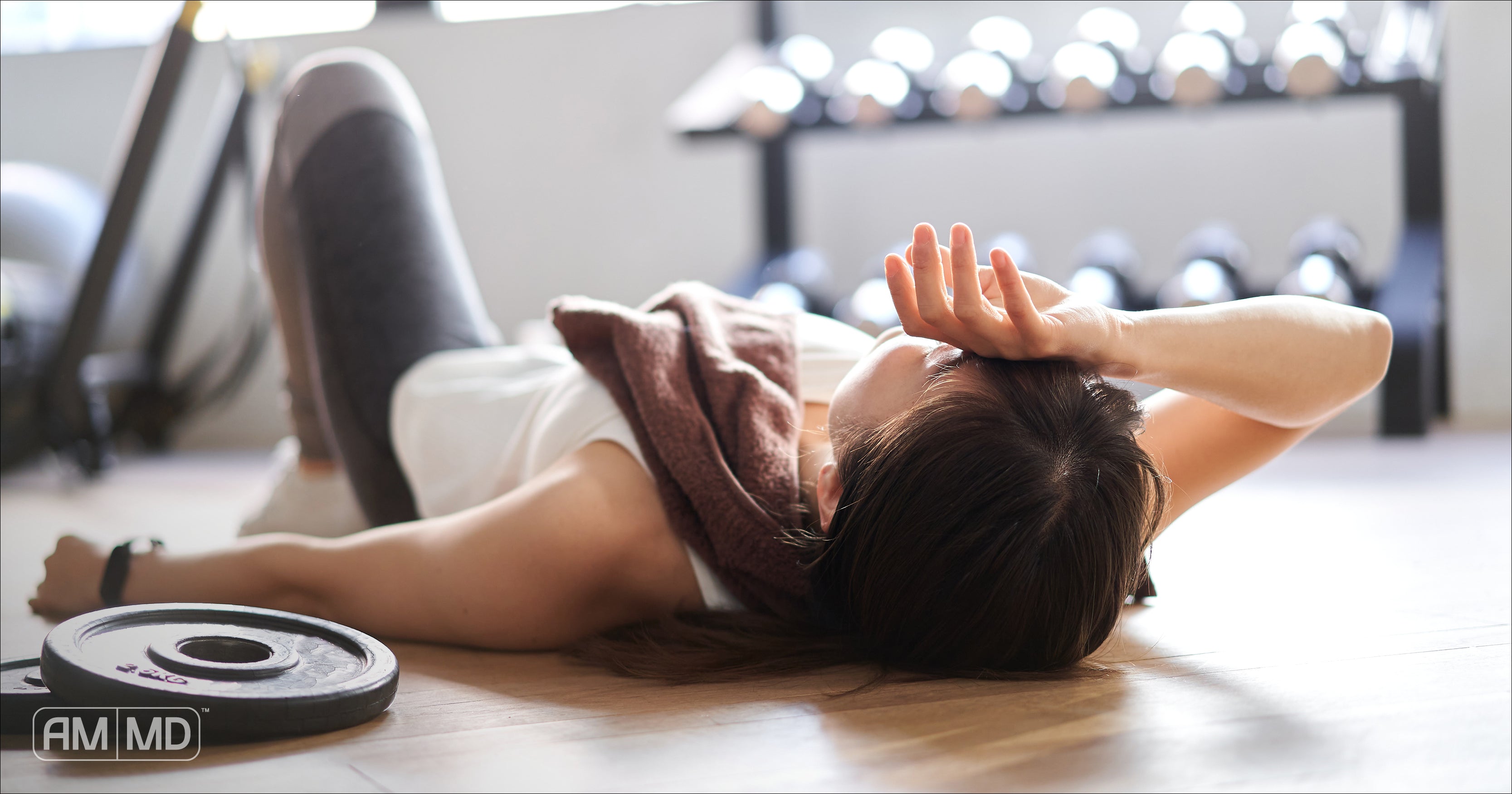 Woman laying on floor exhausted during work out - What is Hypoproteinemia and What to Do About it - AMMD™