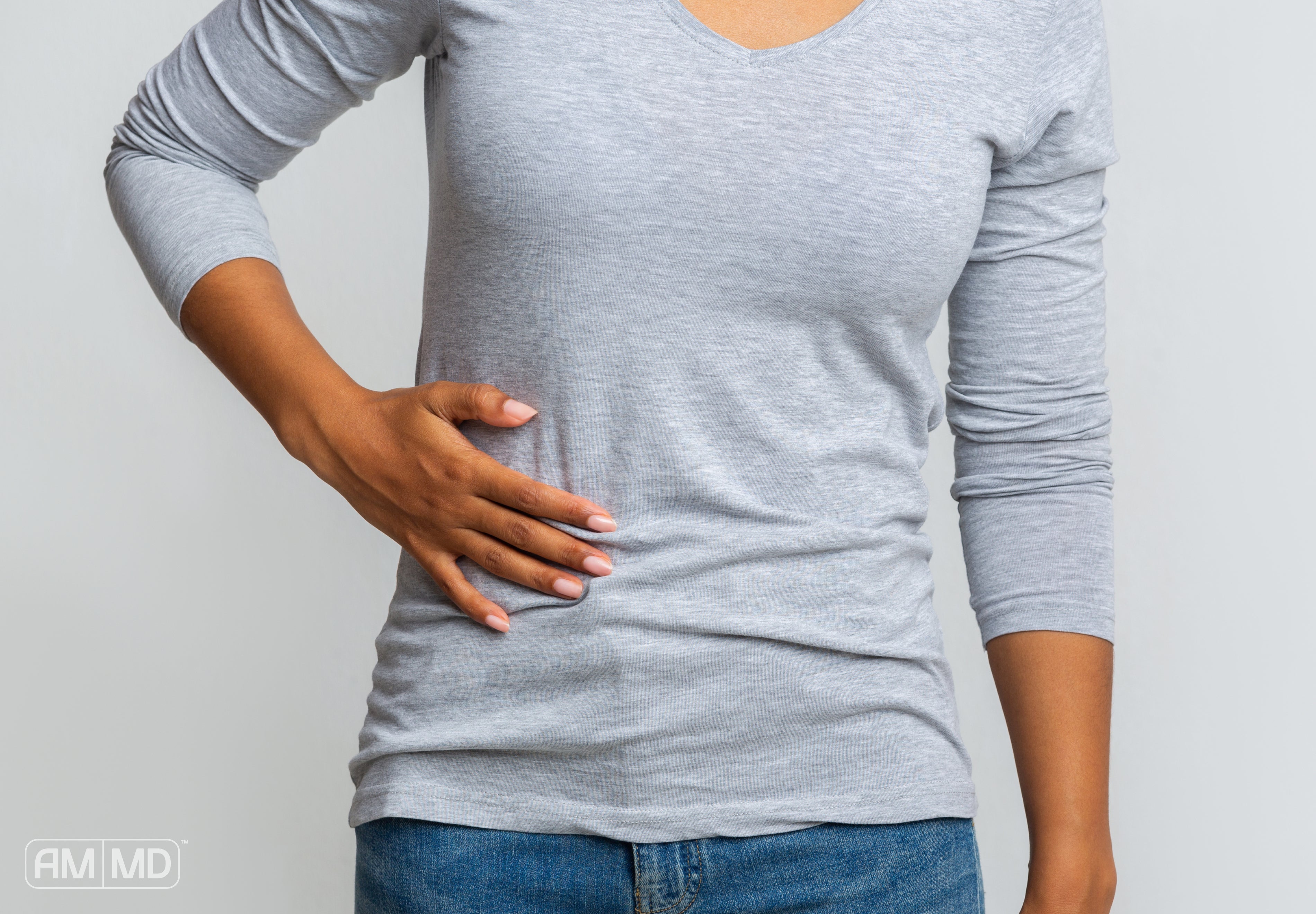 Woman holding her side - What Are Bile Salts & Do You Need To Take a Bile Salts Supplement? - AMMD™