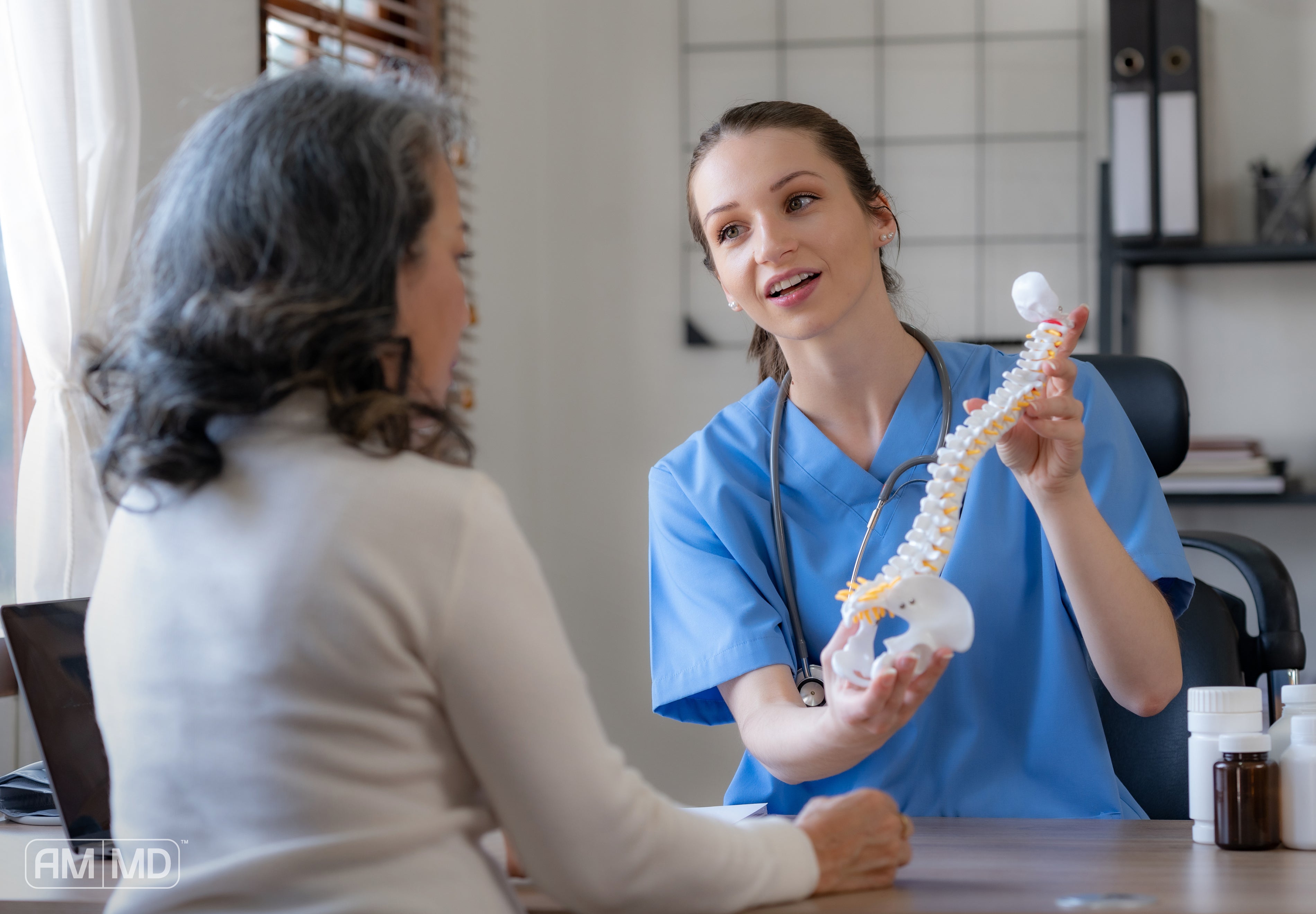 Health practitioner explaining spinal health - What Is Bone Density and Why It Matters for Women - AMMD™
