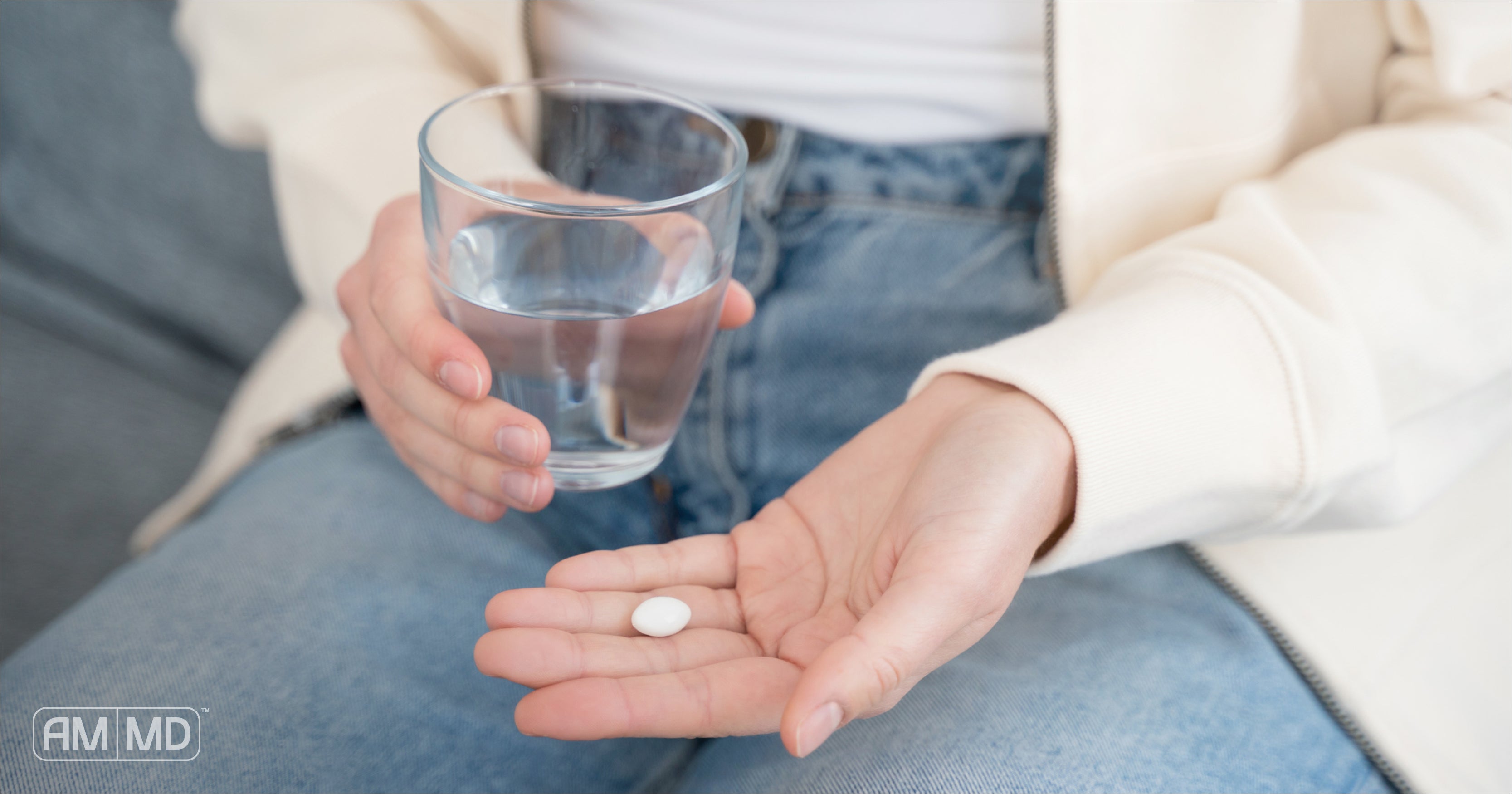 Woman holding glass of water and medication - Which Thyroid Medication is Best? - AMMD™