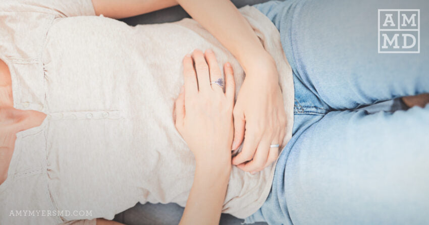 Woman holding stomach - Why Do Women Have More Gut Issues Than Men - Amy Myers MD®