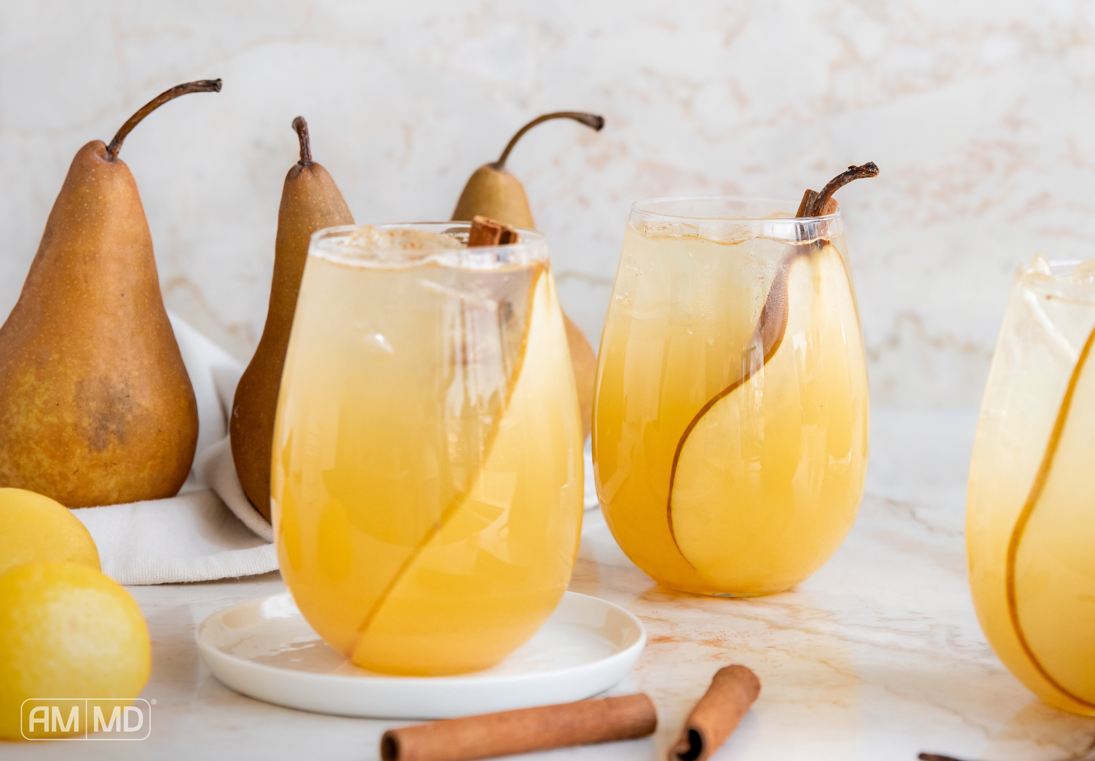 Garnished glasses filled with Ginger Pear Collagen Punch - AMMD™