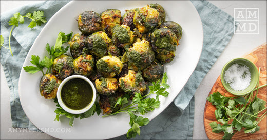 Smashed Brussels Sprouts on a plate with Organic Greens sauce - Amy Myers MD®