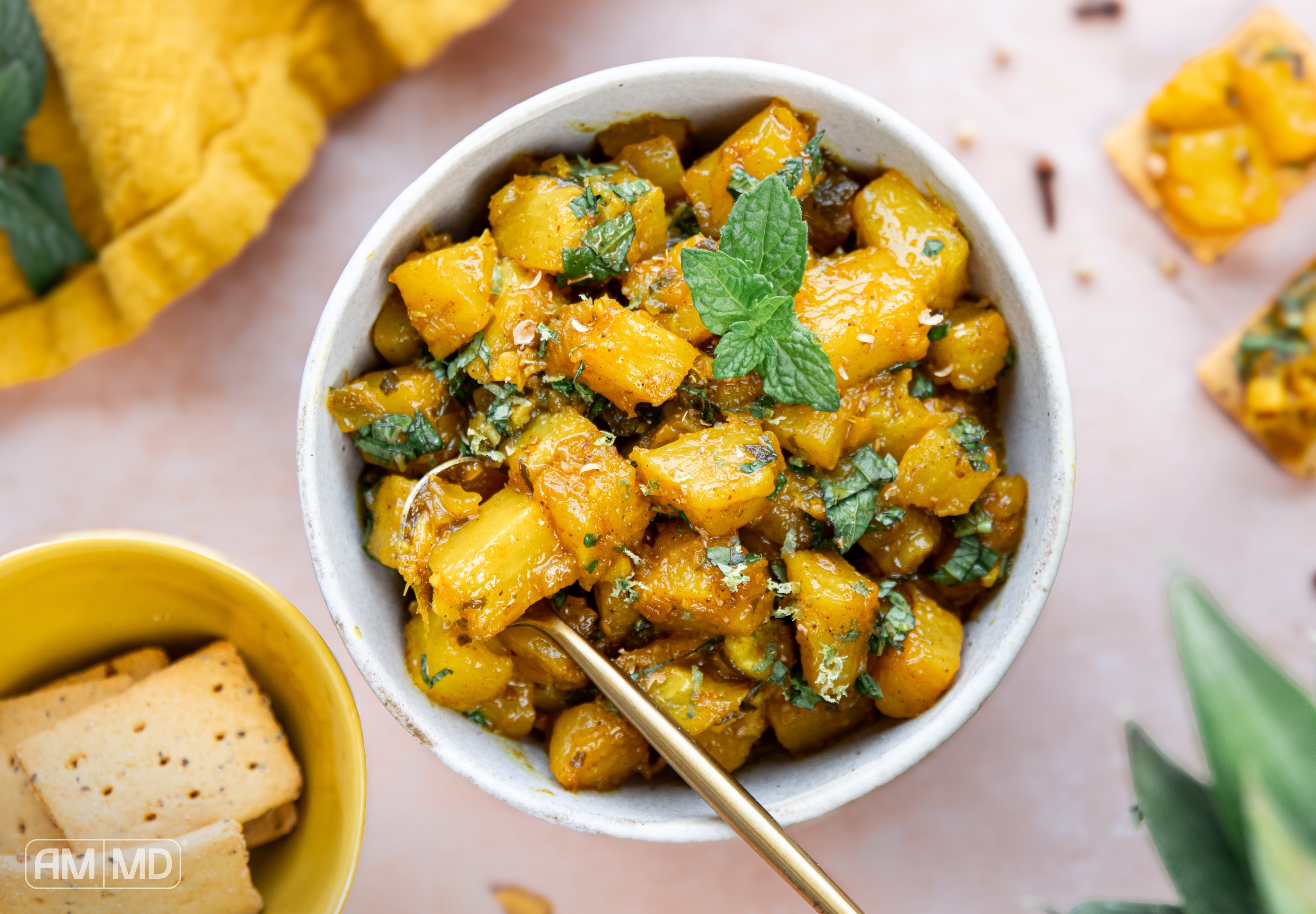 Homemade spiced pineapple chutney with fresh mint and lime zest served as a healthy gluten-free condiment