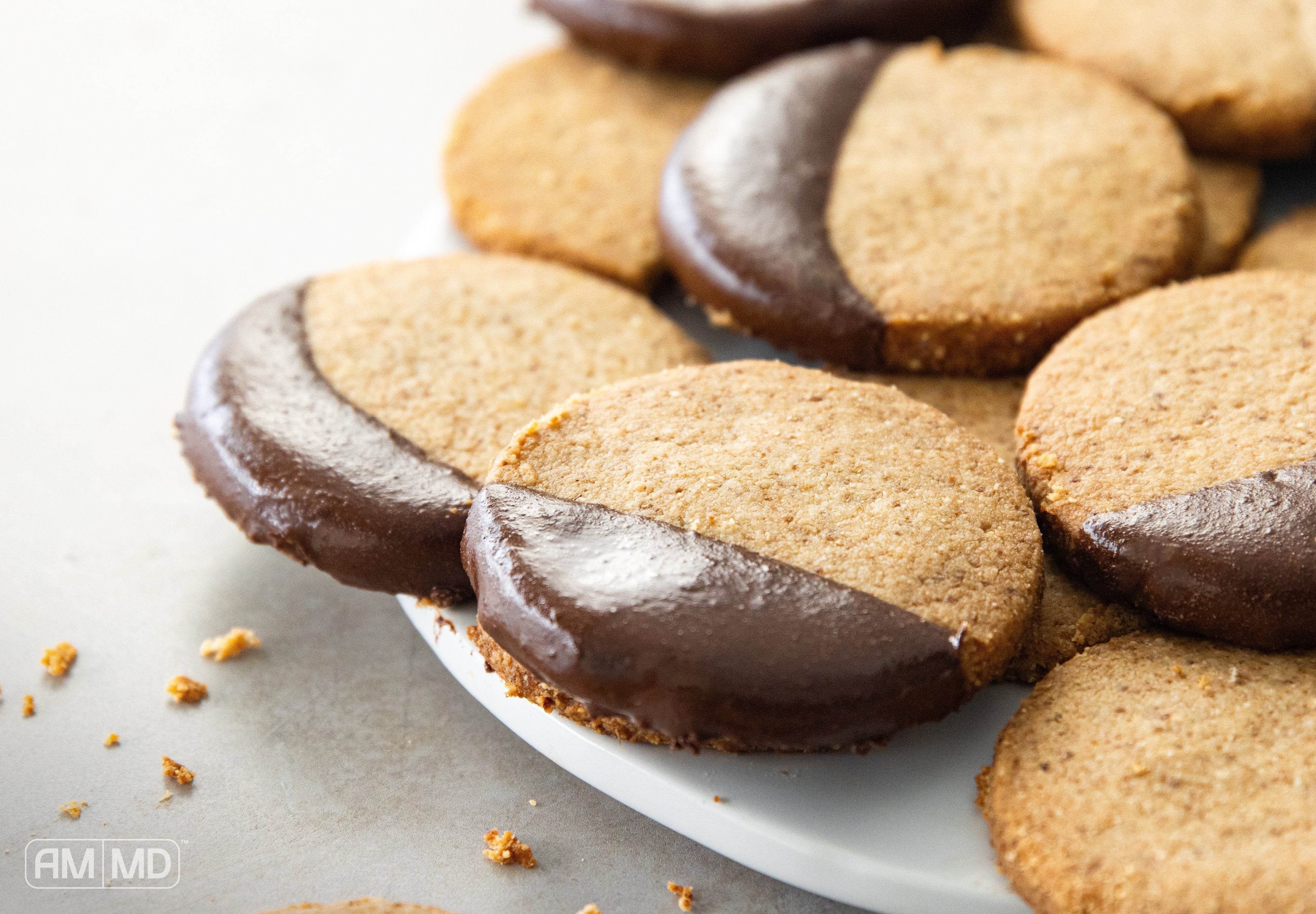 Gluten Free Shortbread Cookies dipped in cookies on a plate - AMMD™